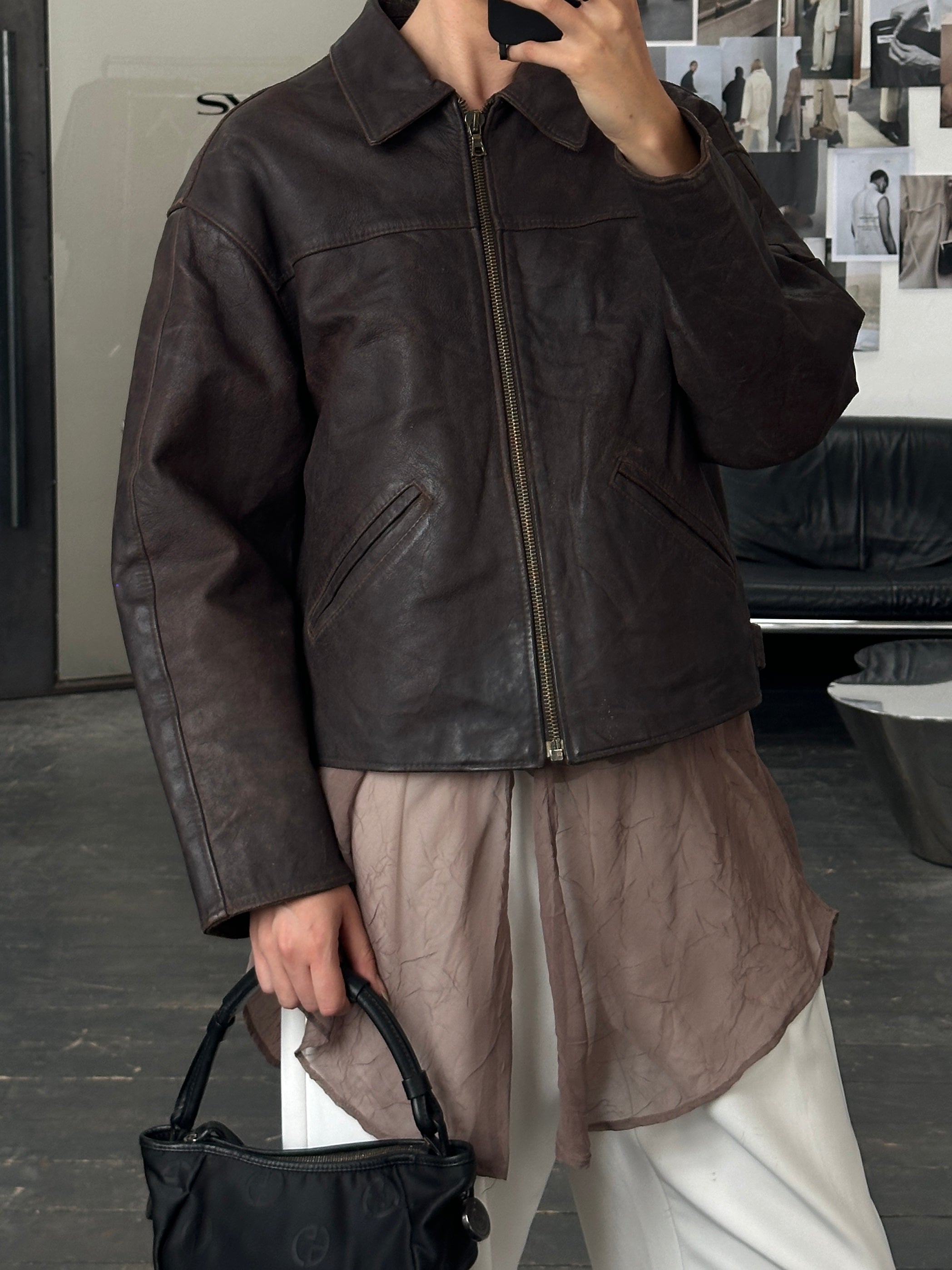 Vintage 1980s cropped leather jacket, size large, featuring classic design and distressed brown leather details.