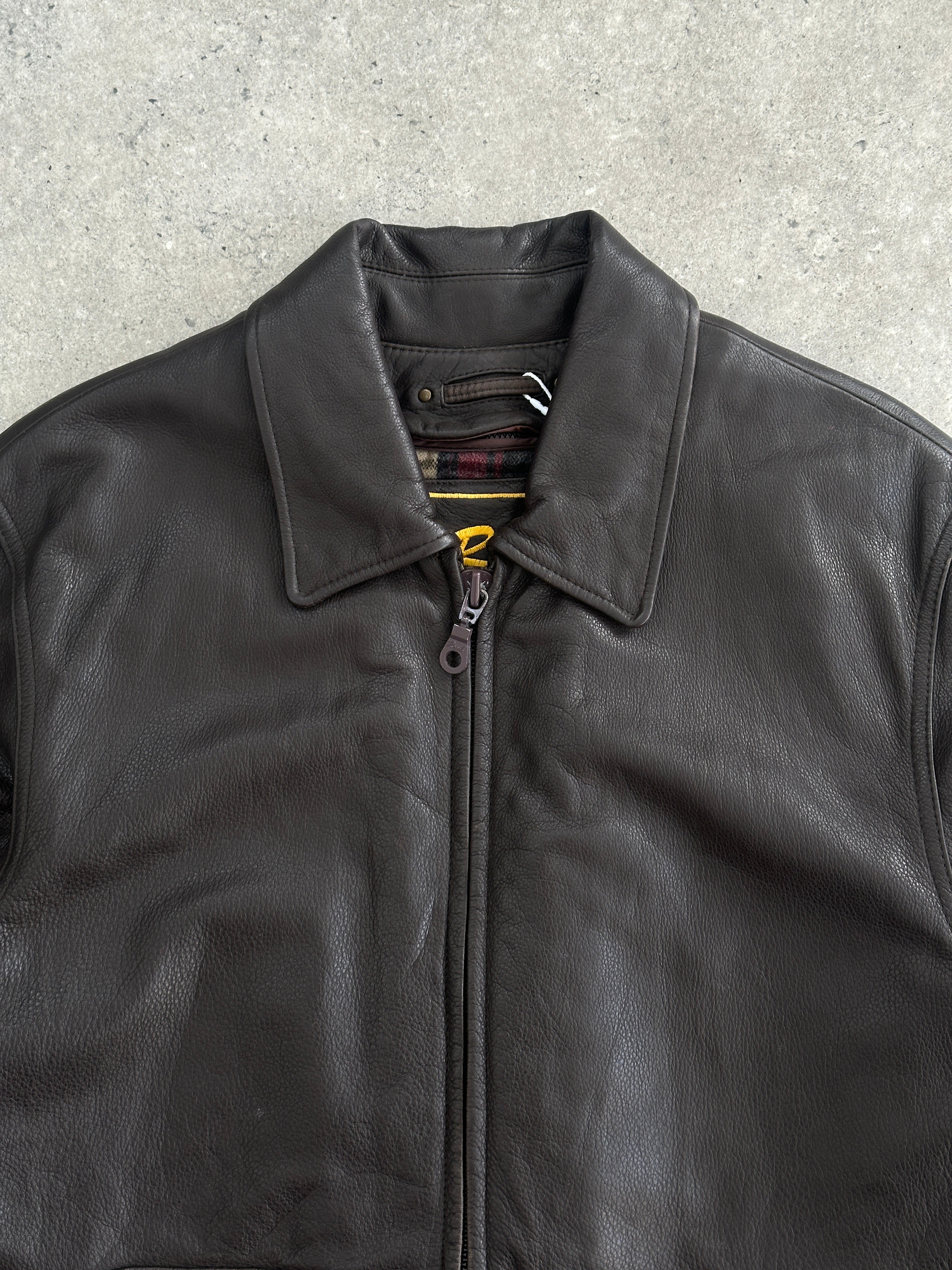 Vintage boxy leather jacket in size large, featuring a classic design with a structured fit and smooth leather texture.