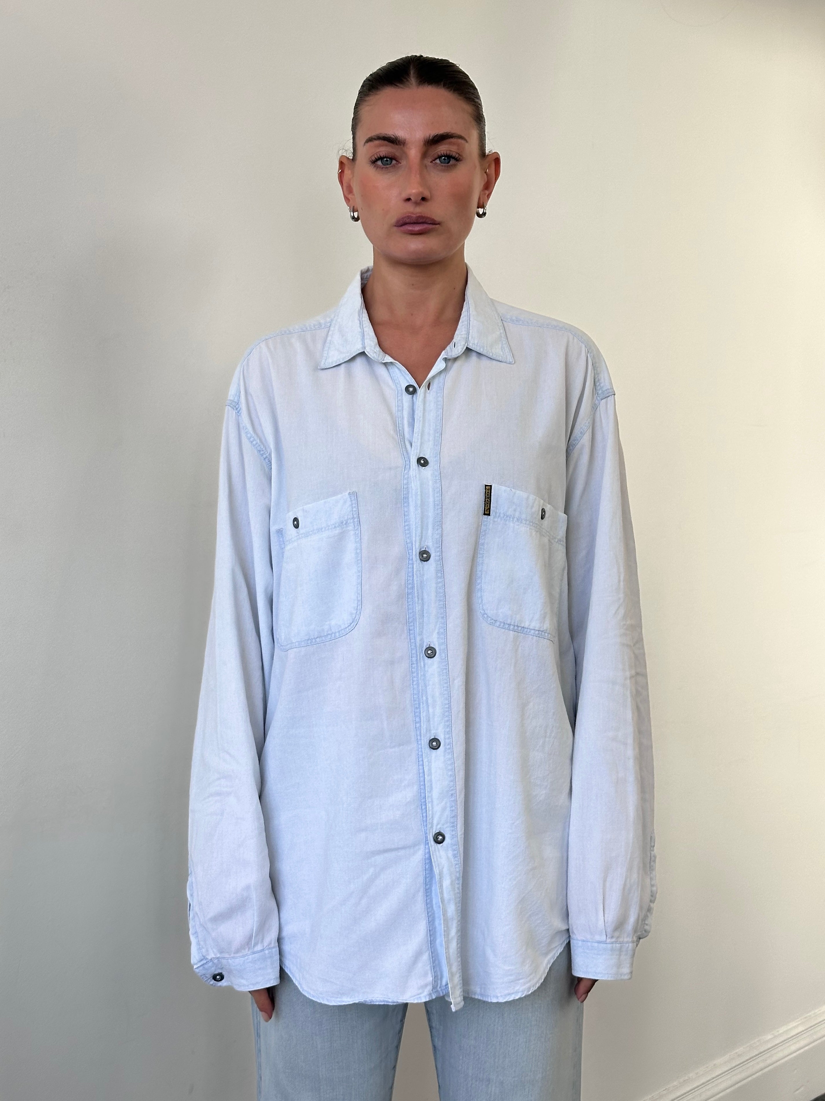 Armani Jeans light wash denim shirt in size XL, featuring classic collar and button-front design.