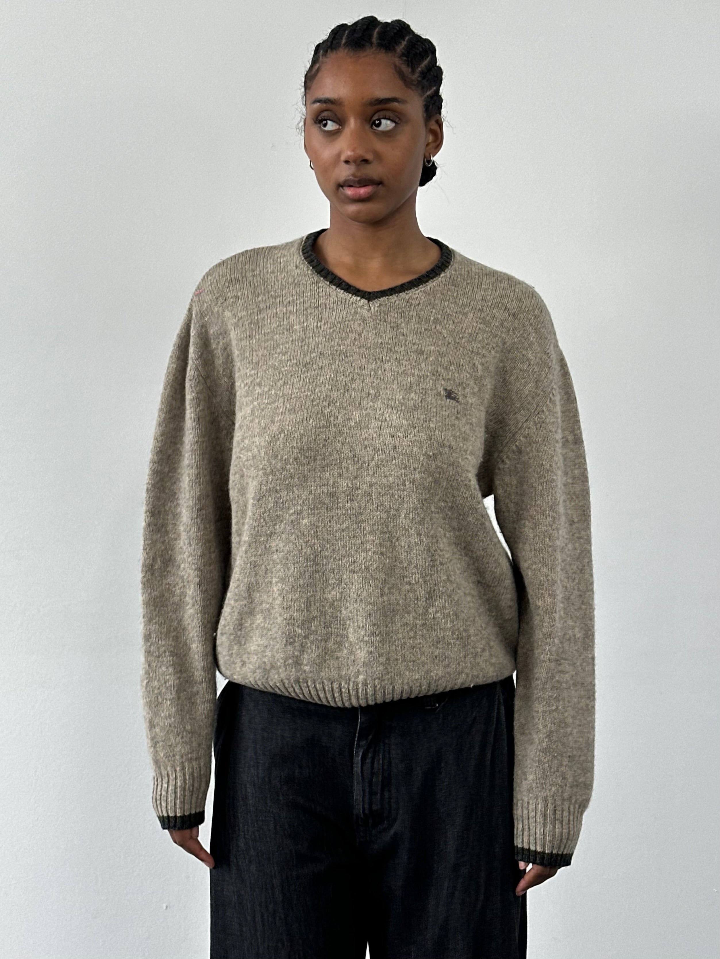 Burberry London 2000s merino wool v-neck knitted jumper in black, featuring a classic design and ribbed cuffs and hem.