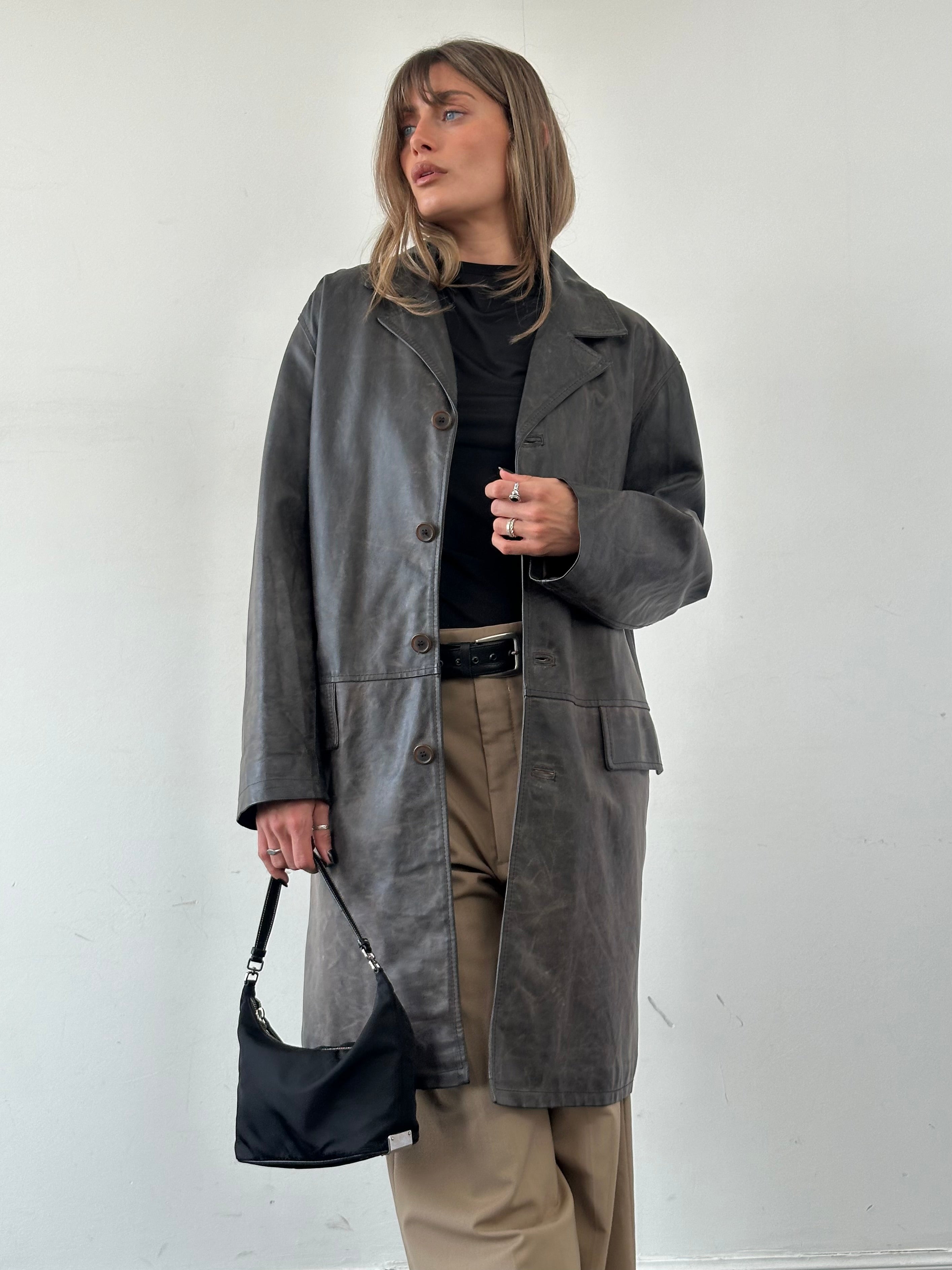 Vintage Italian distressed leather jacket in size L with a rugged, worn-in look, featuring classic styling and detailed leather texture.