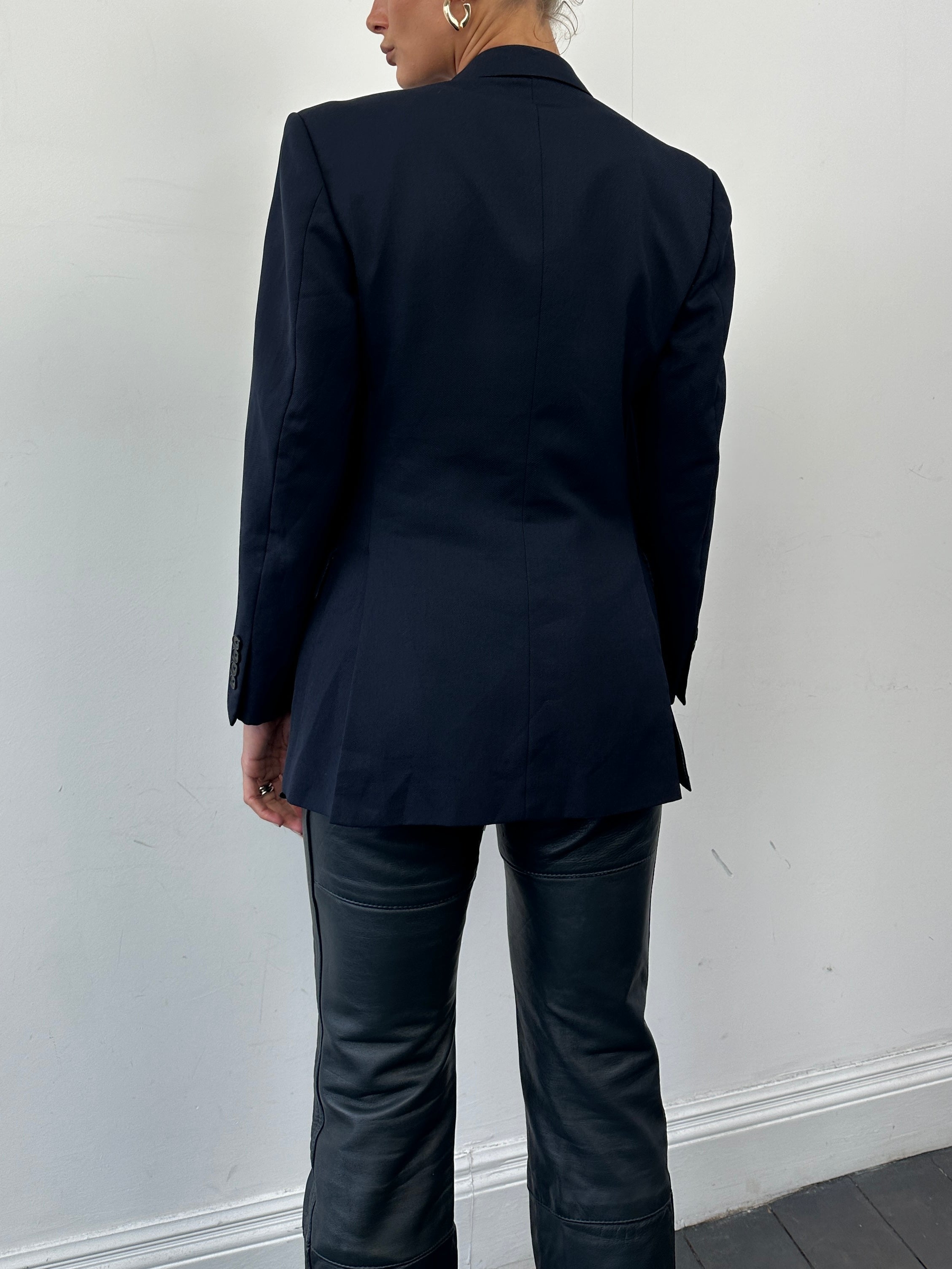 Christian Dior wool single-breasted blazer in XS/S, tailored fit with classic lapel, shown on a hanger against a neutral background.