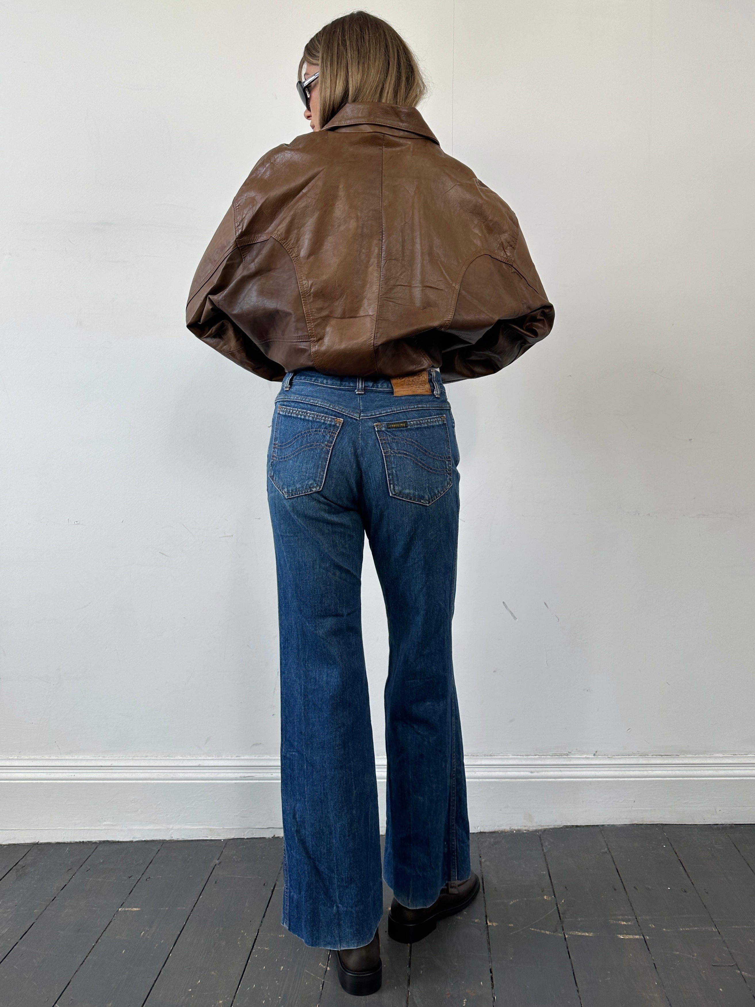 Carrera Italian straight leg denim jeans in size W30, featuring classic blue wash and modern fit, shown on a hanger.
