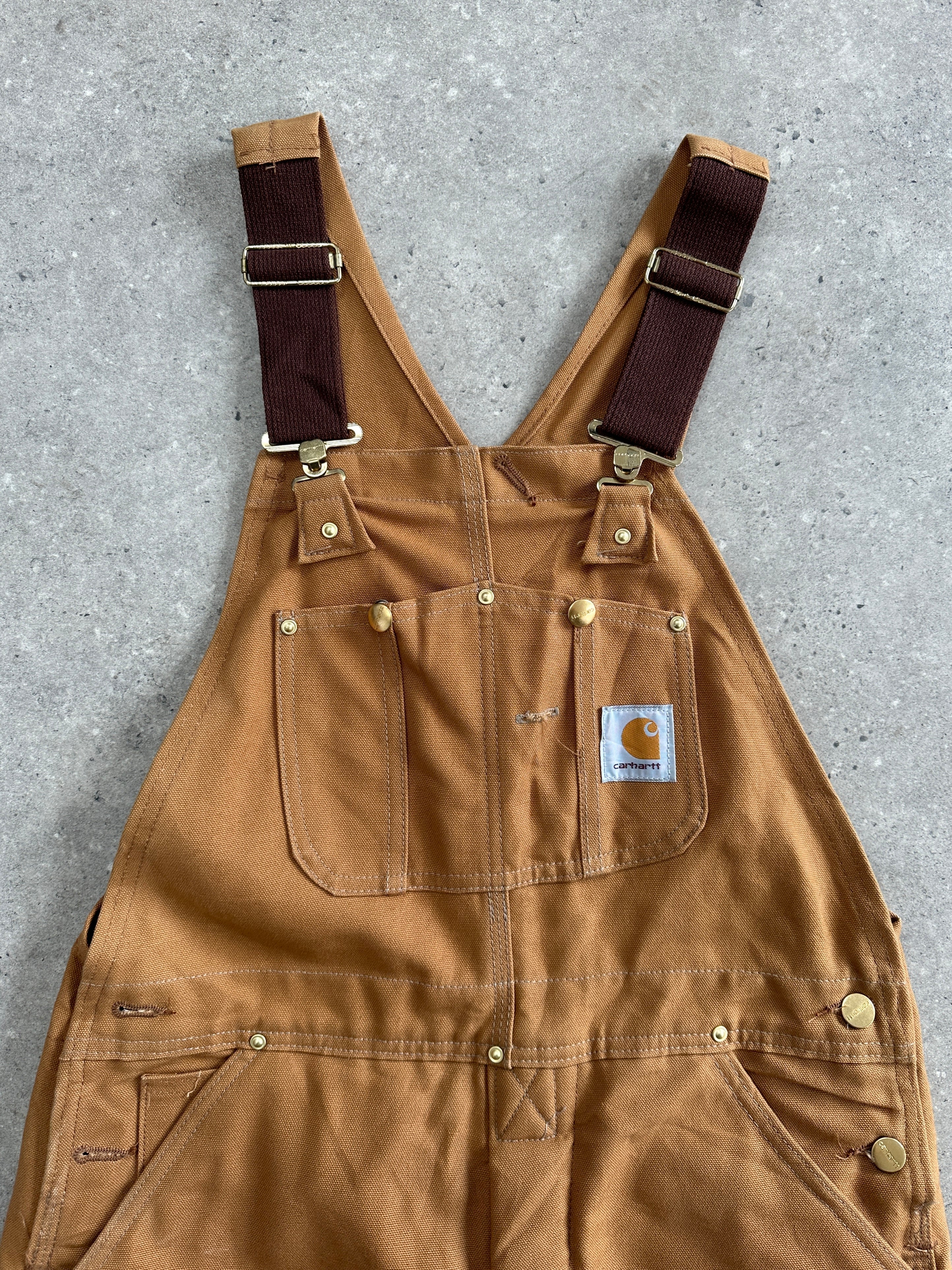 Carhartt pure cotton dungarees in size M, featuring durable fabric, classic fit, and adjustable straps for workwear or casual use.