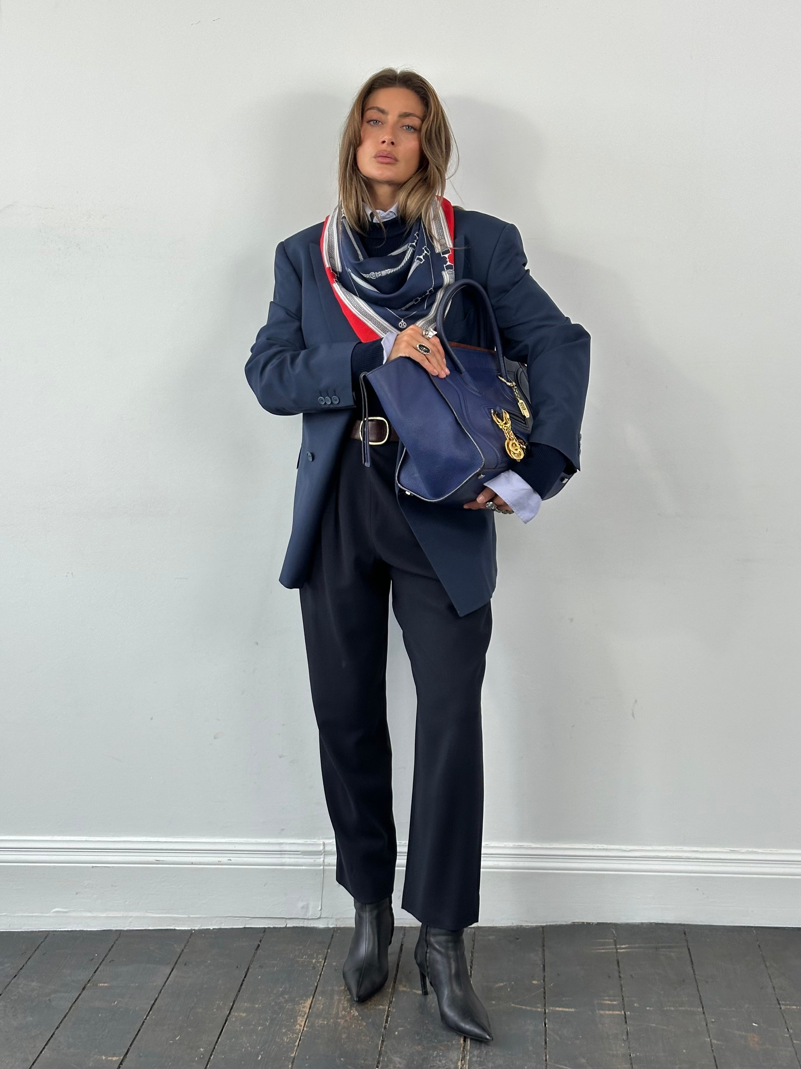 Giorgio Armani 1990s high-waisted pure wool tapered trousers in W28, shown on a hanger, with classic tailored fit and dark color.