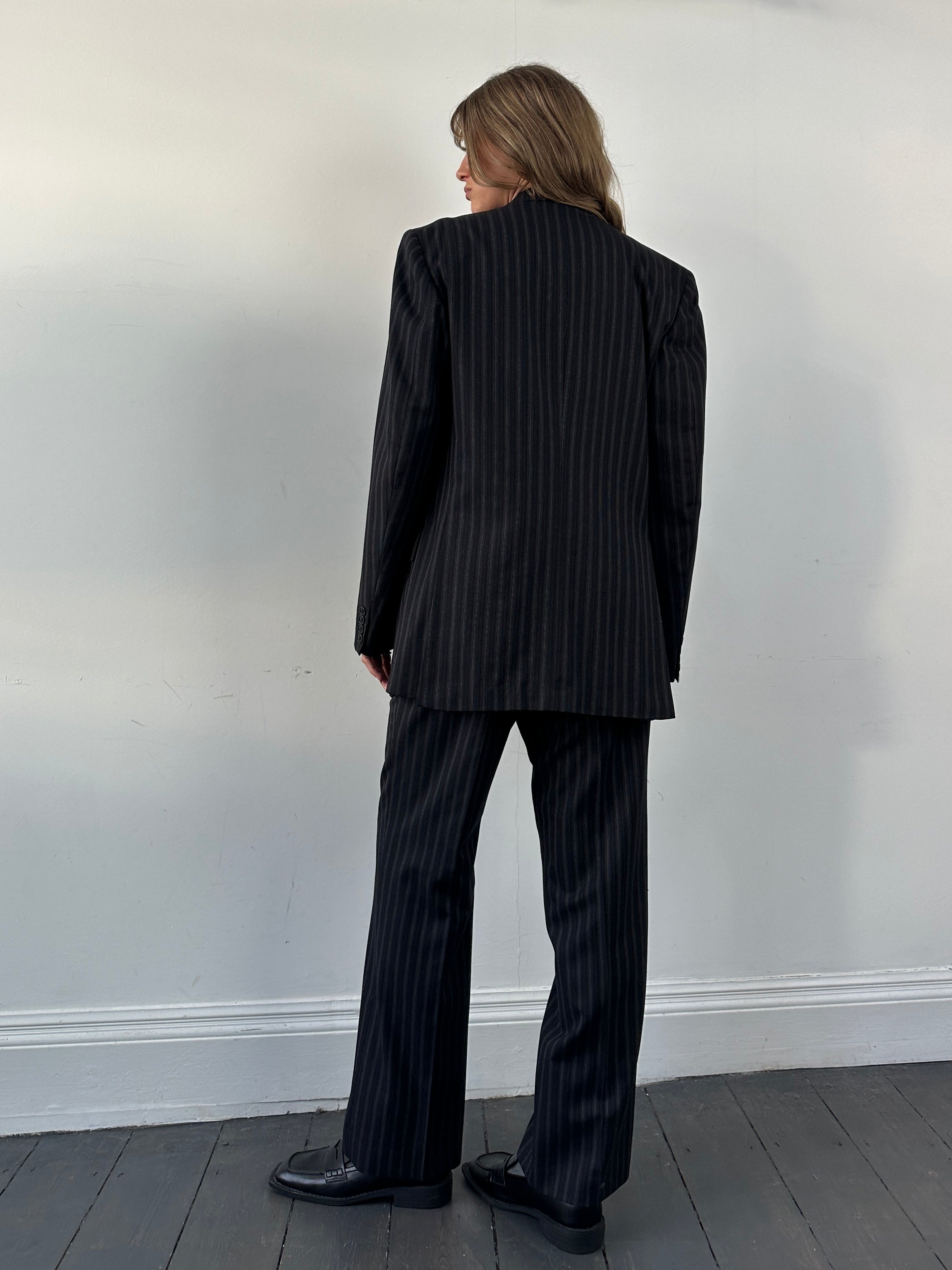 Christian Dior pure wool pinstripe jumpsuit in size 42L/W34, featuring a tailored fit with pinstripe pattern and classic lapel.