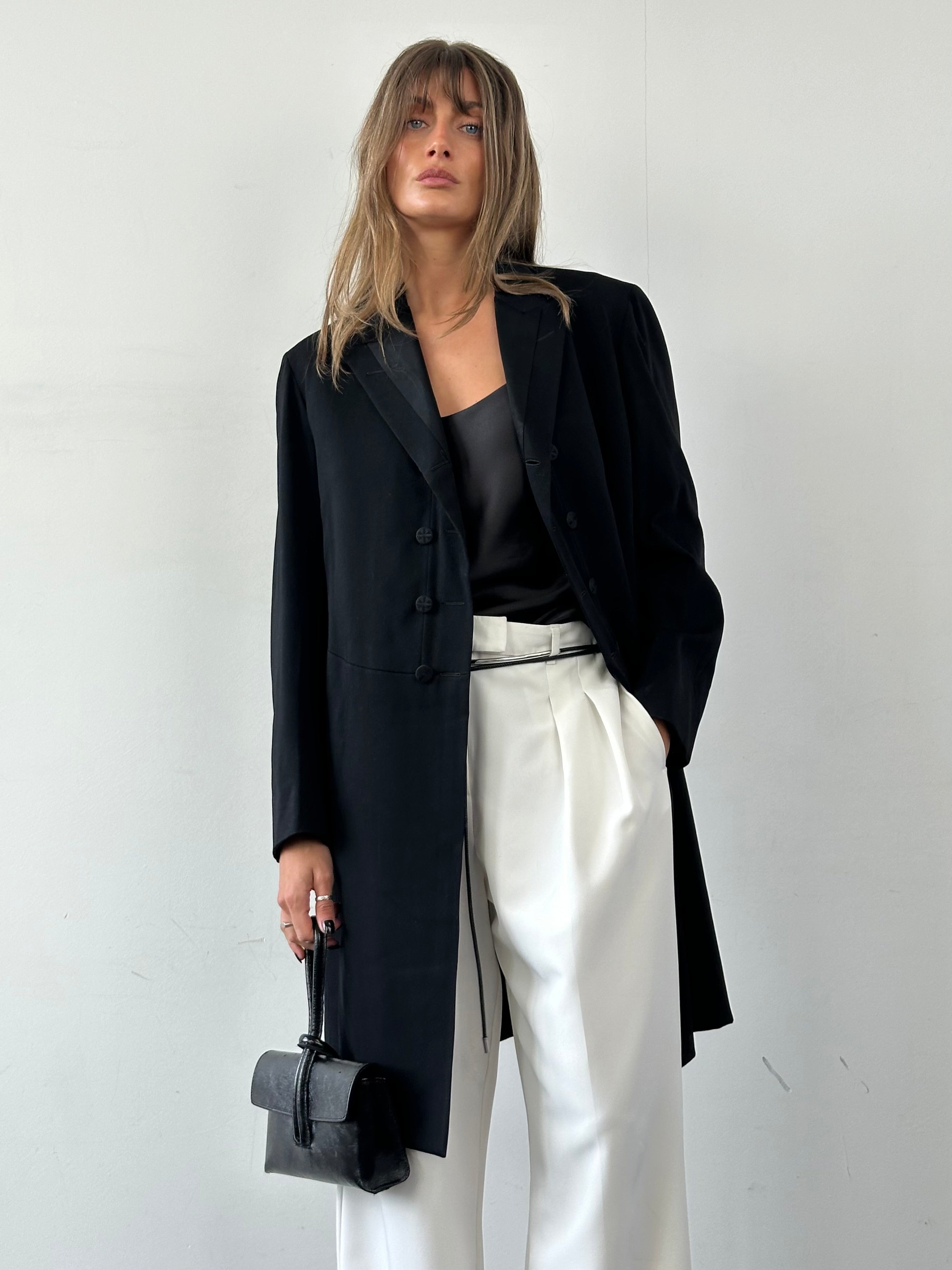 Vintage men's tuxedo coat in size M/L, classic black formal coat with satin lapels and tailored fit, styled for elegant occasions.