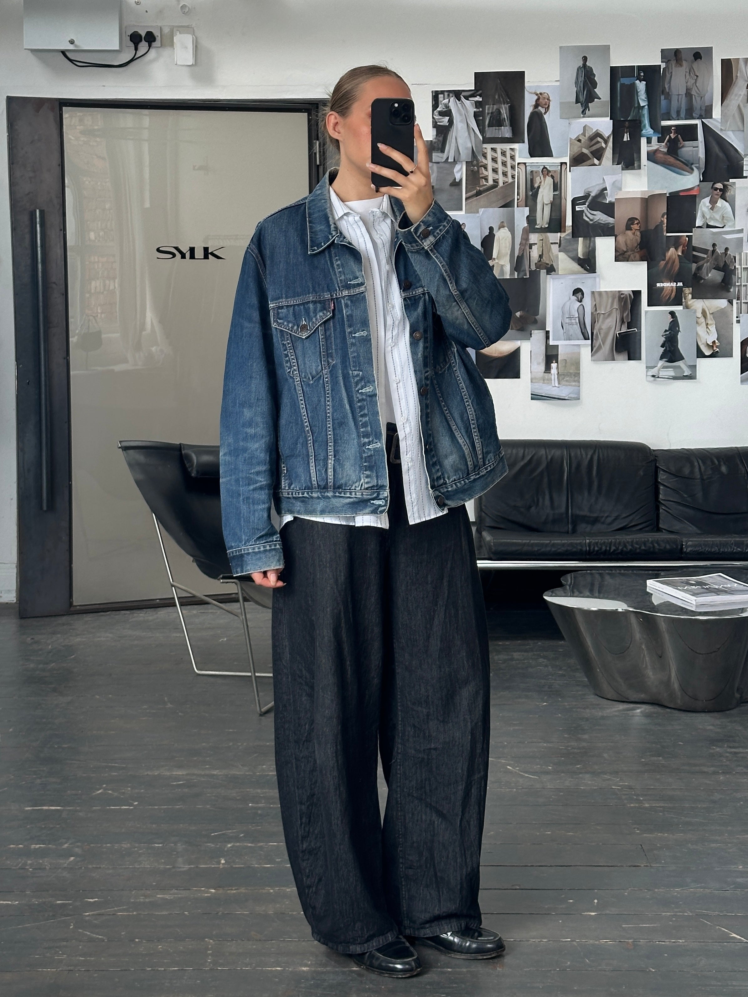 Levi’s 1990s mid wash denim jacket in size XL displayed on a hanger, featuring classic stitching and vintage style.