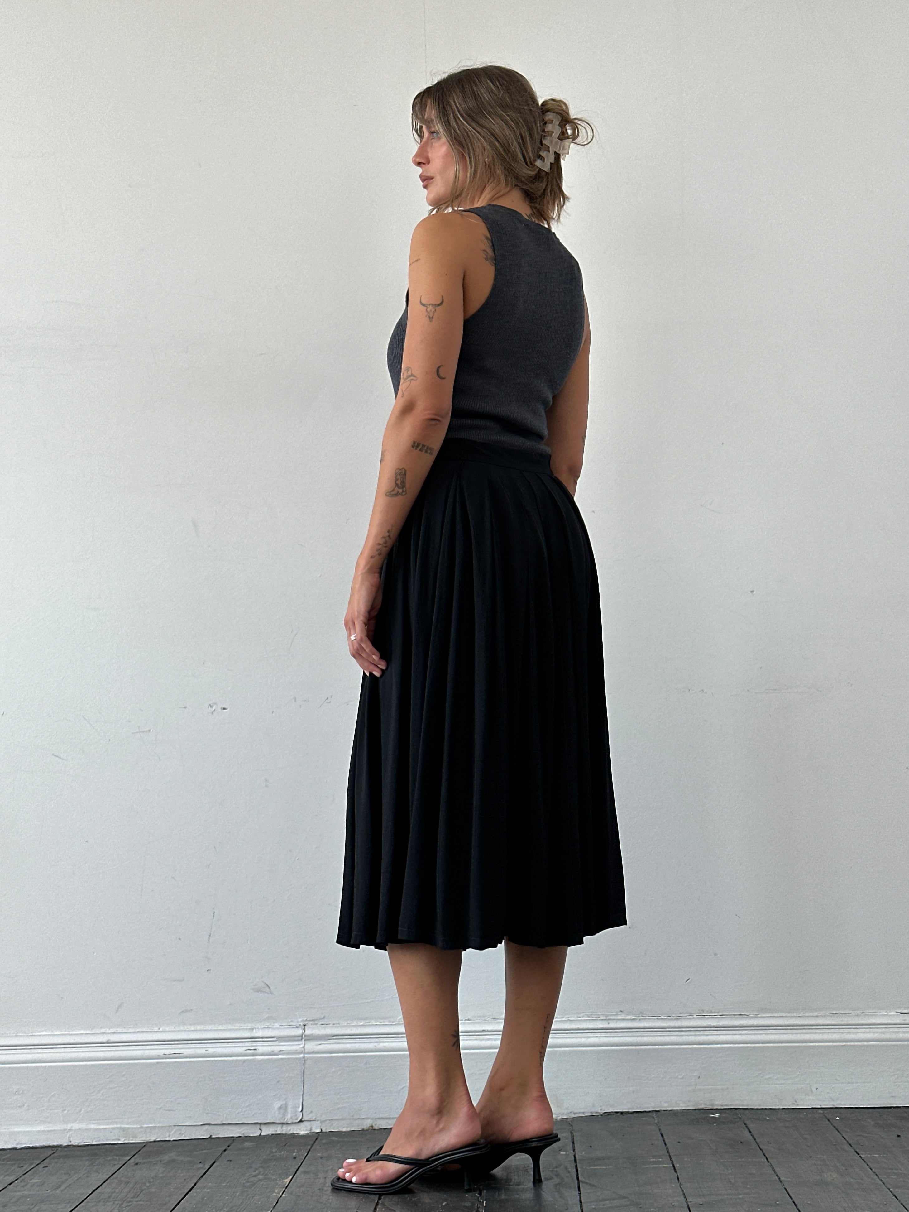 Iceberg pleated belted midi skirt in W28, shown with flowing fabric and stylish belt detail.