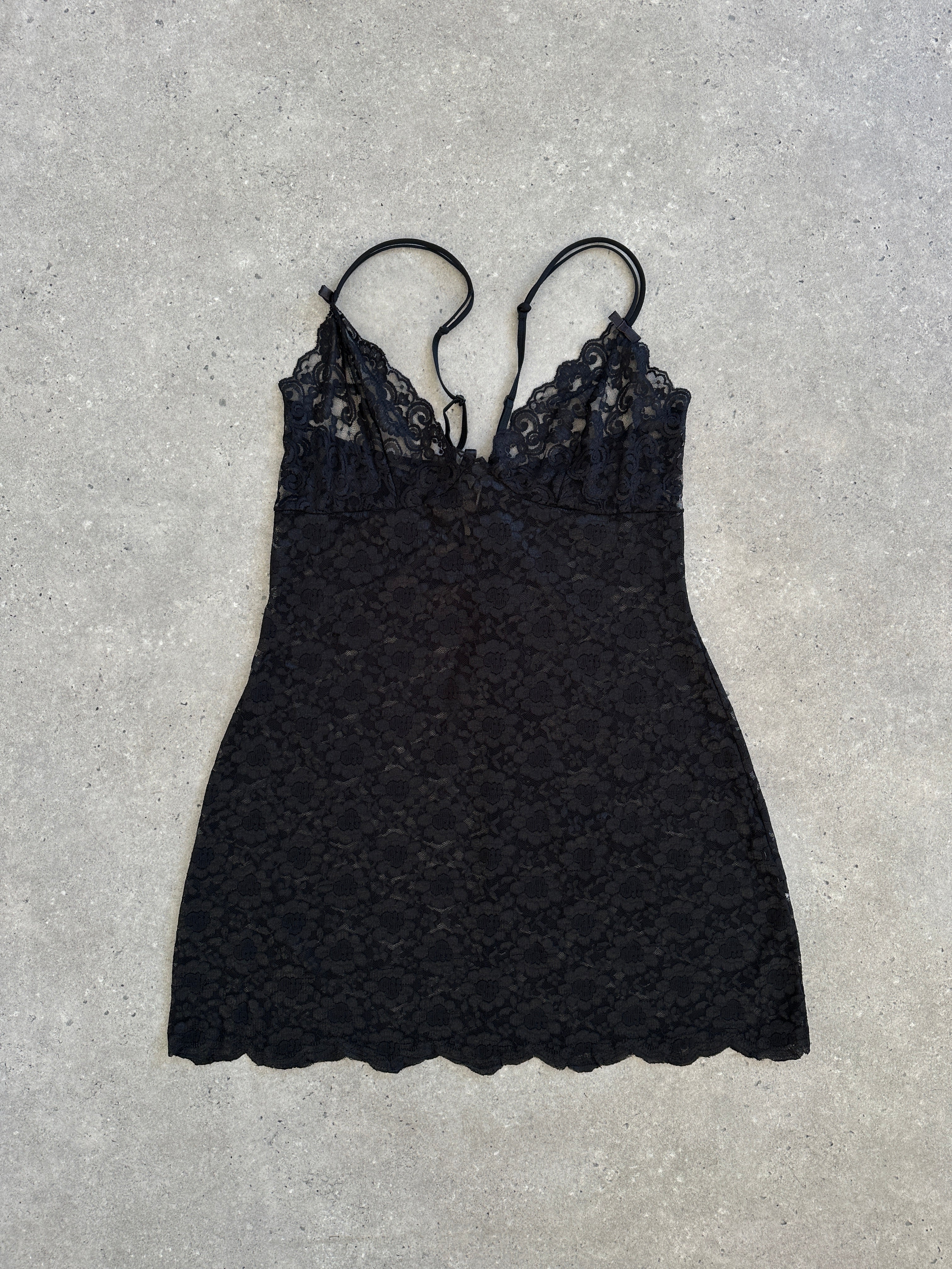 Vintage 1990s sheer lace mini slip dress in size large, featuring delicate lace details and a classic vintage style.
