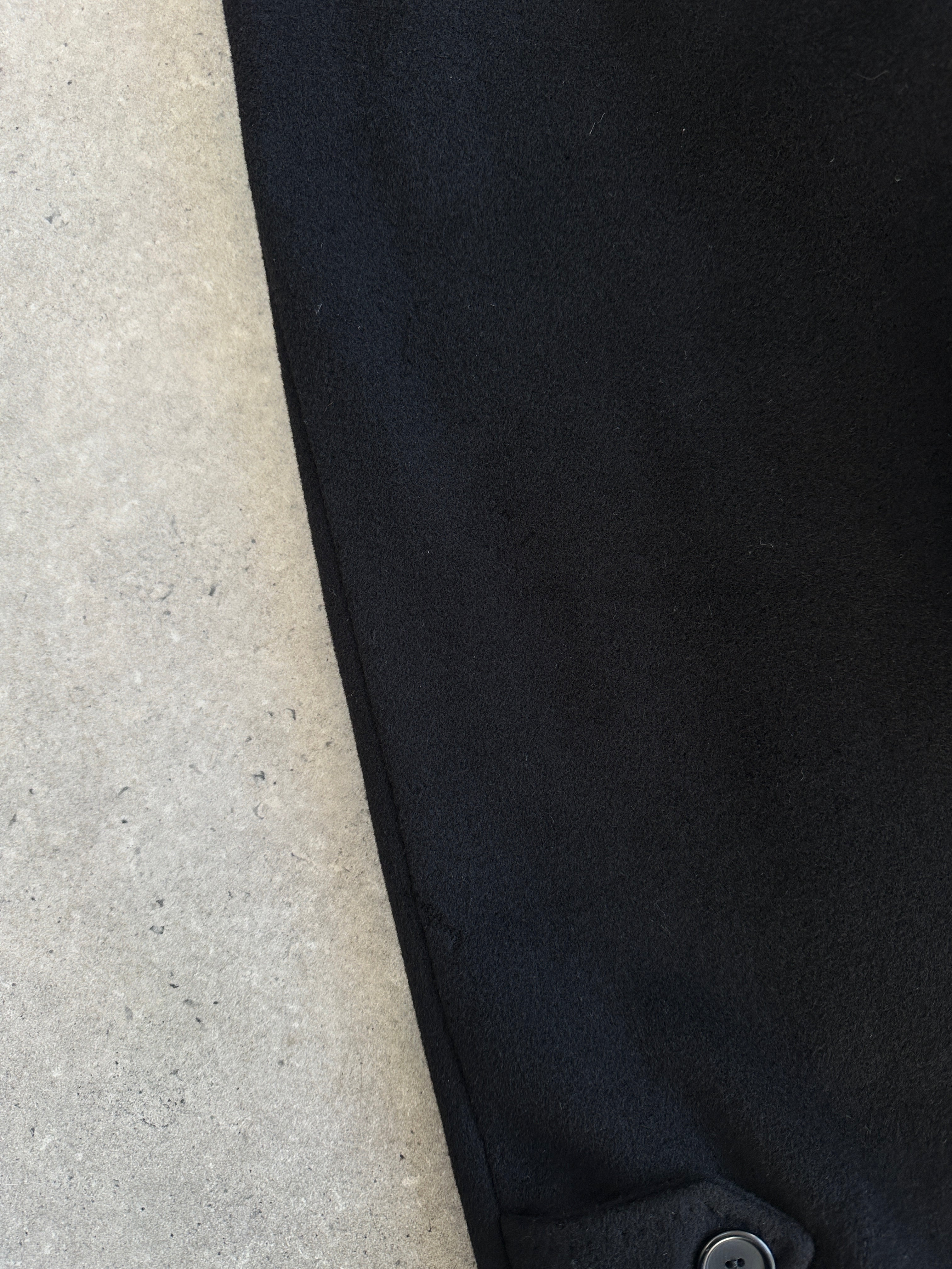 Vintage Italian 1990s wool cashmere belted coat in XL, stylish and warm, shown hanging on a hanger with a classic design.