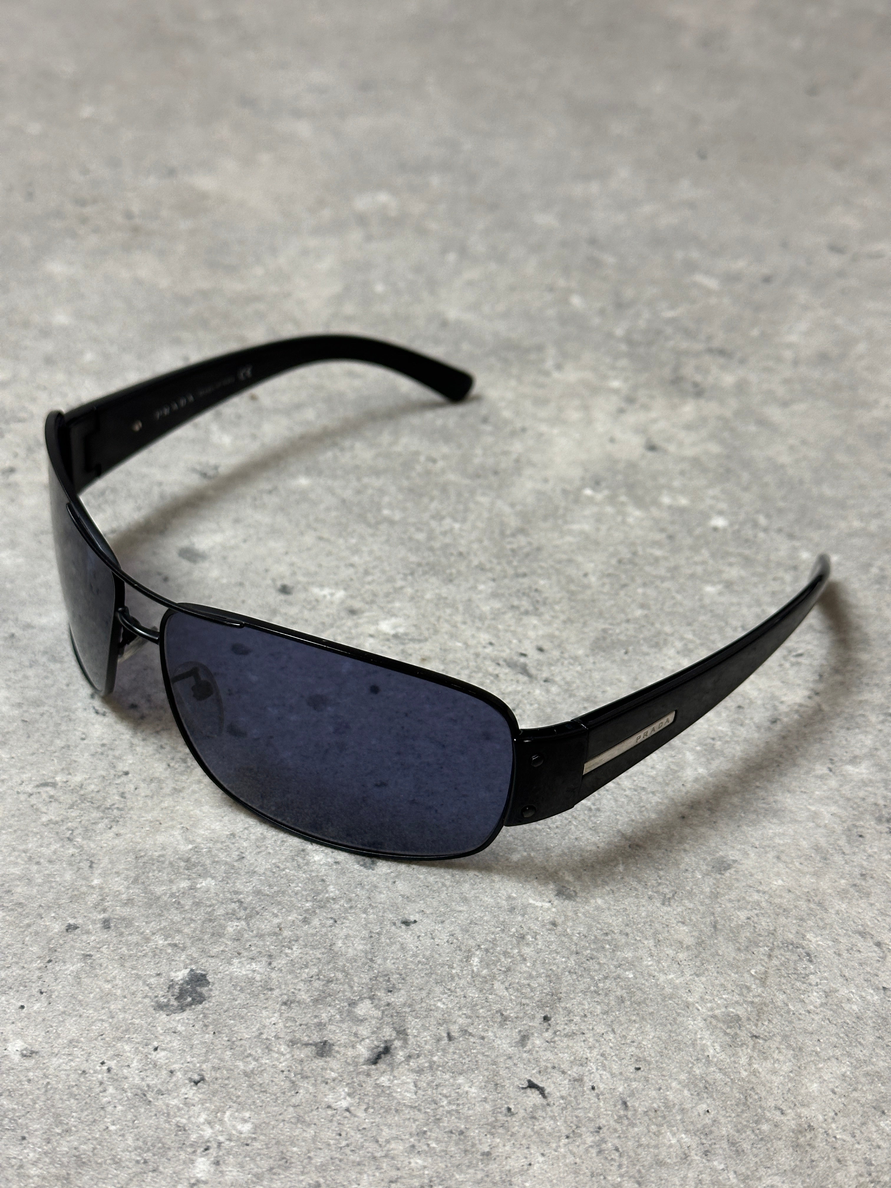 Prada aviator shield sunglasses with dark tinted lenses and metal frame, stylish eyewear for sun protection.
