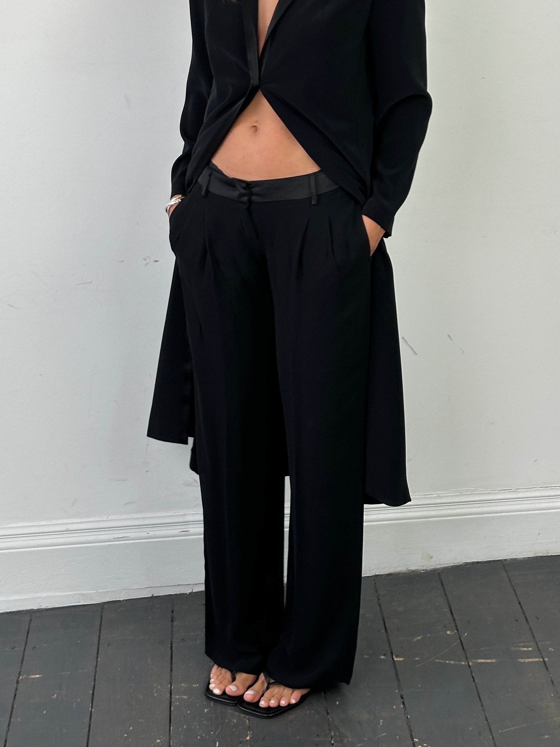 Valentino low waist wide-leg tuxedo trousers in black, front view showing tailored fit and clean design.