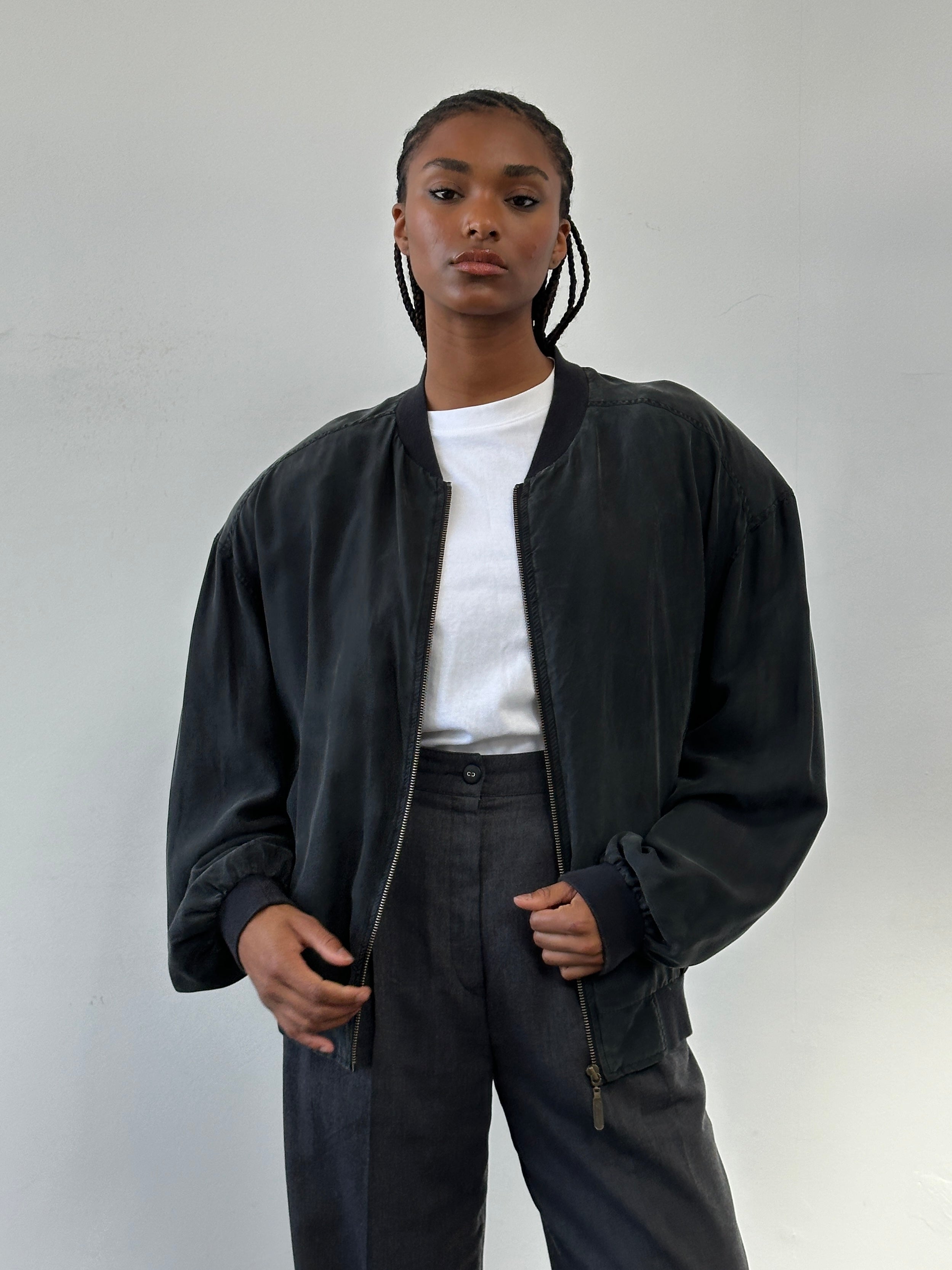 Vintage 1990s pure silk bomber jacket in size large, with a sleek design and classic style, displayed on a hanger.