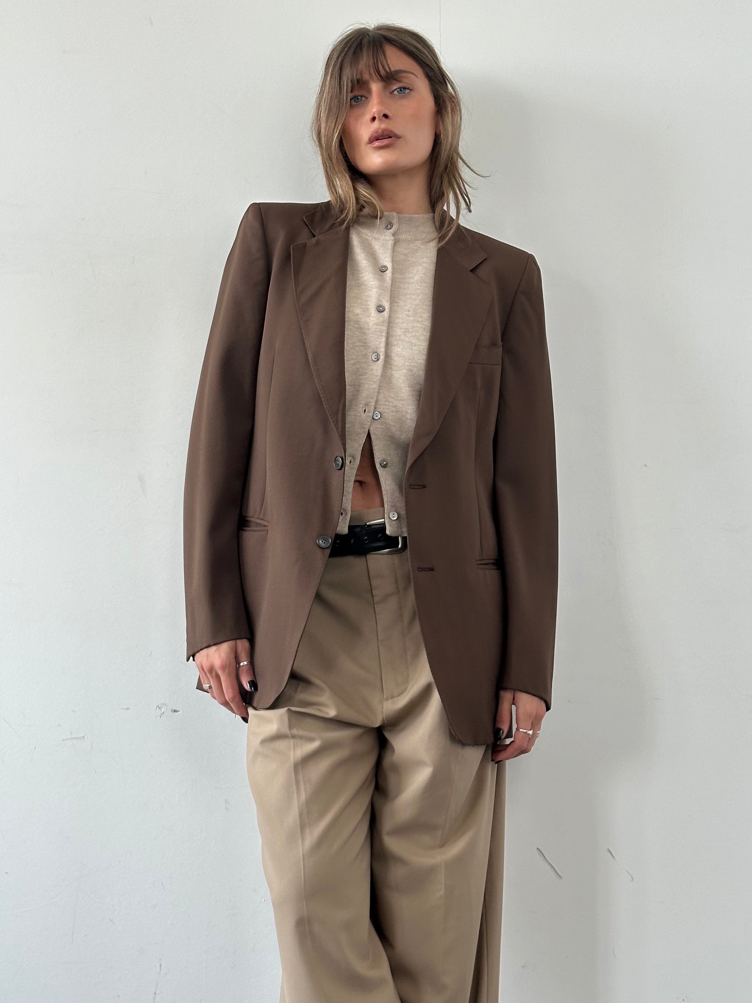 Vintage Italian vintage pure wool single-breasted blazer in size S/M, showing the classic tailored fit and fabric texture.