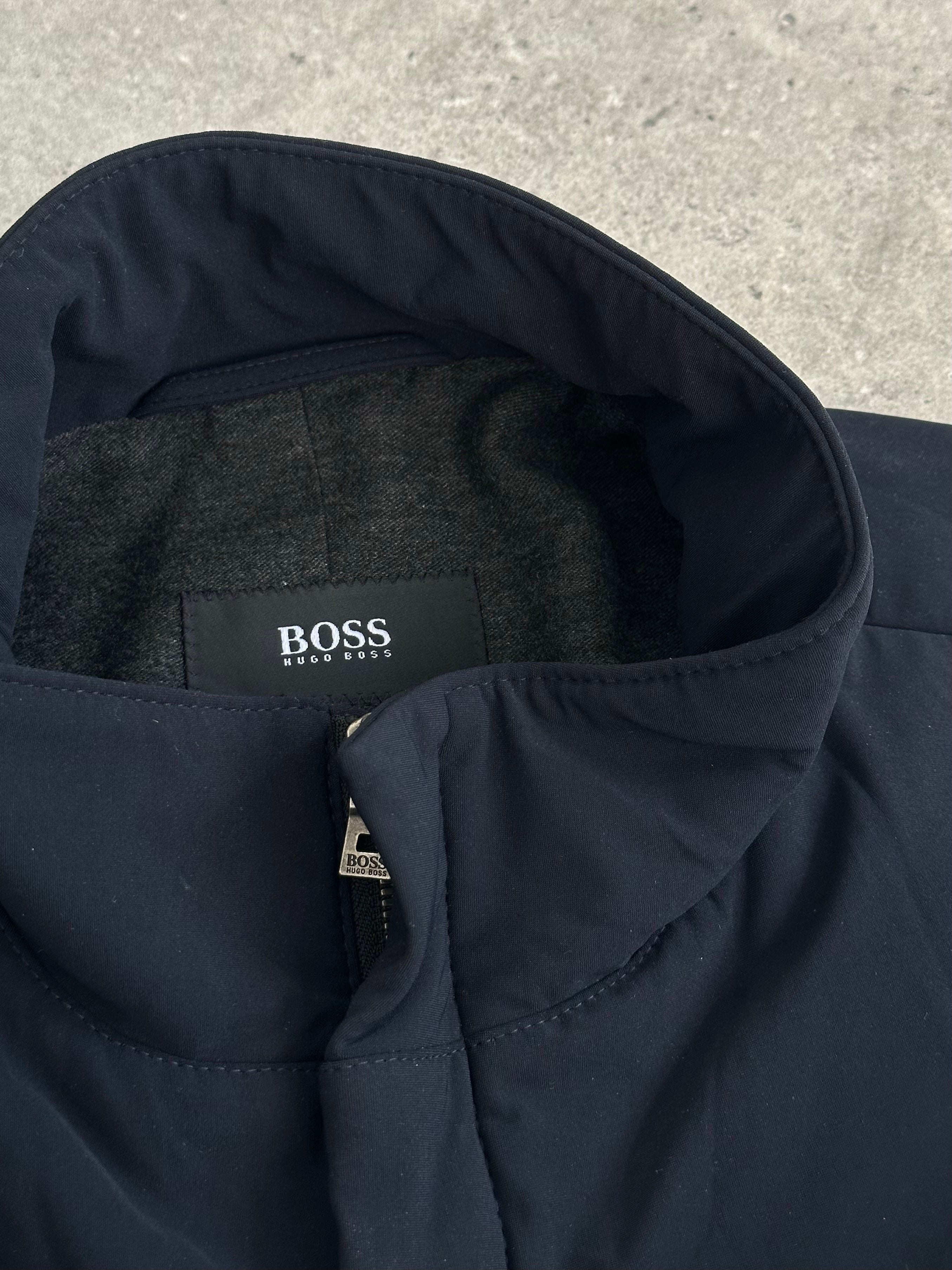 Hugo Boss 2000s cotton trench coat with high neck and double zip closure, in size L, displayed on a hanger.