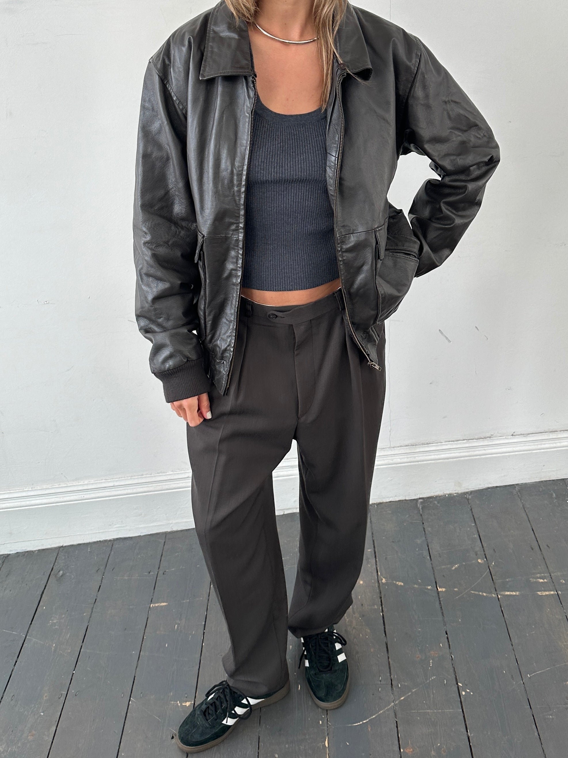 Vintage smooth leather bomber jacket in size large, featuring classic design and sleek texture.
