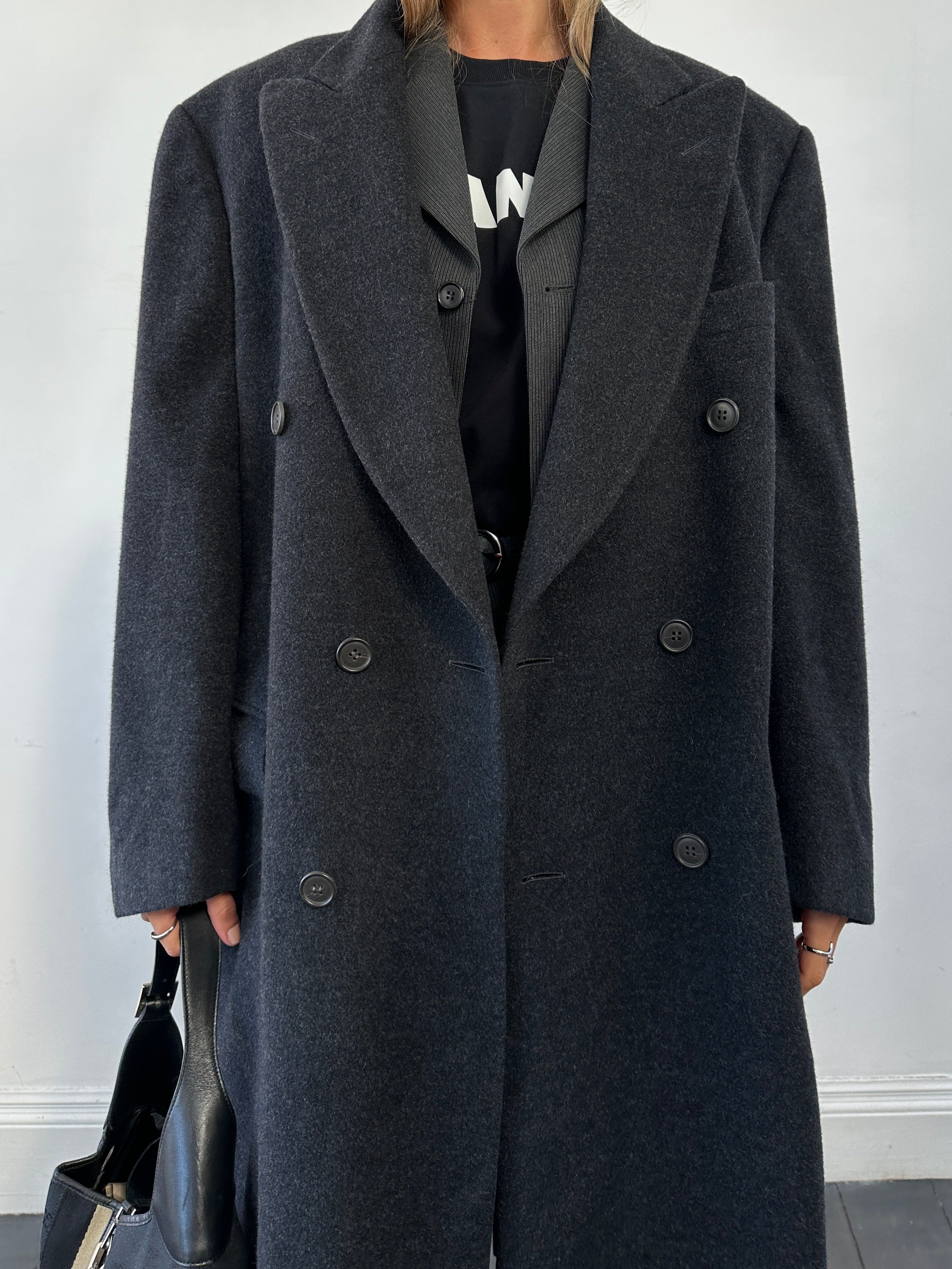 Vintage brand vintage cashmere wool double-breasted coat in size XL, showing classic style and textured fabric.