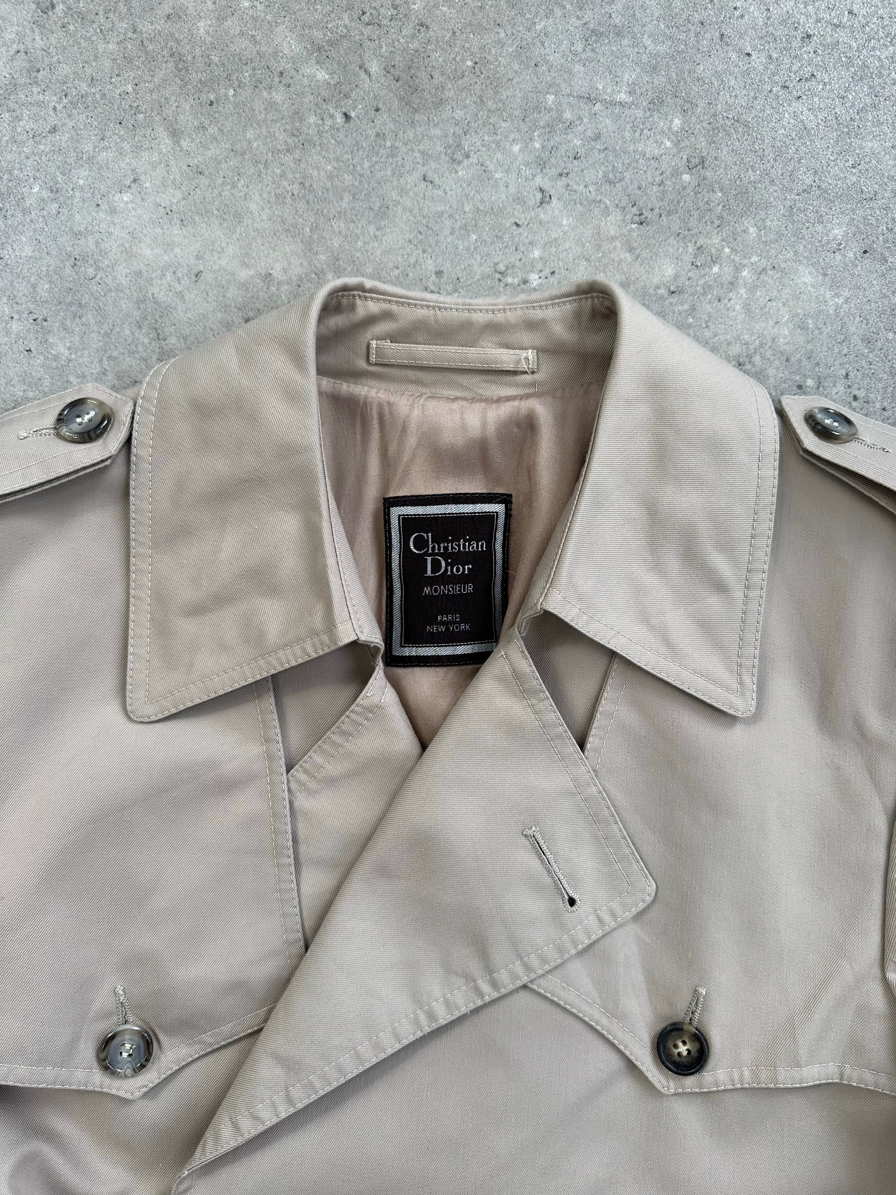Christian Dior 1980s cotton double-breasted trench coat, size M, shown on a hanger with classic beige color and tailored design.