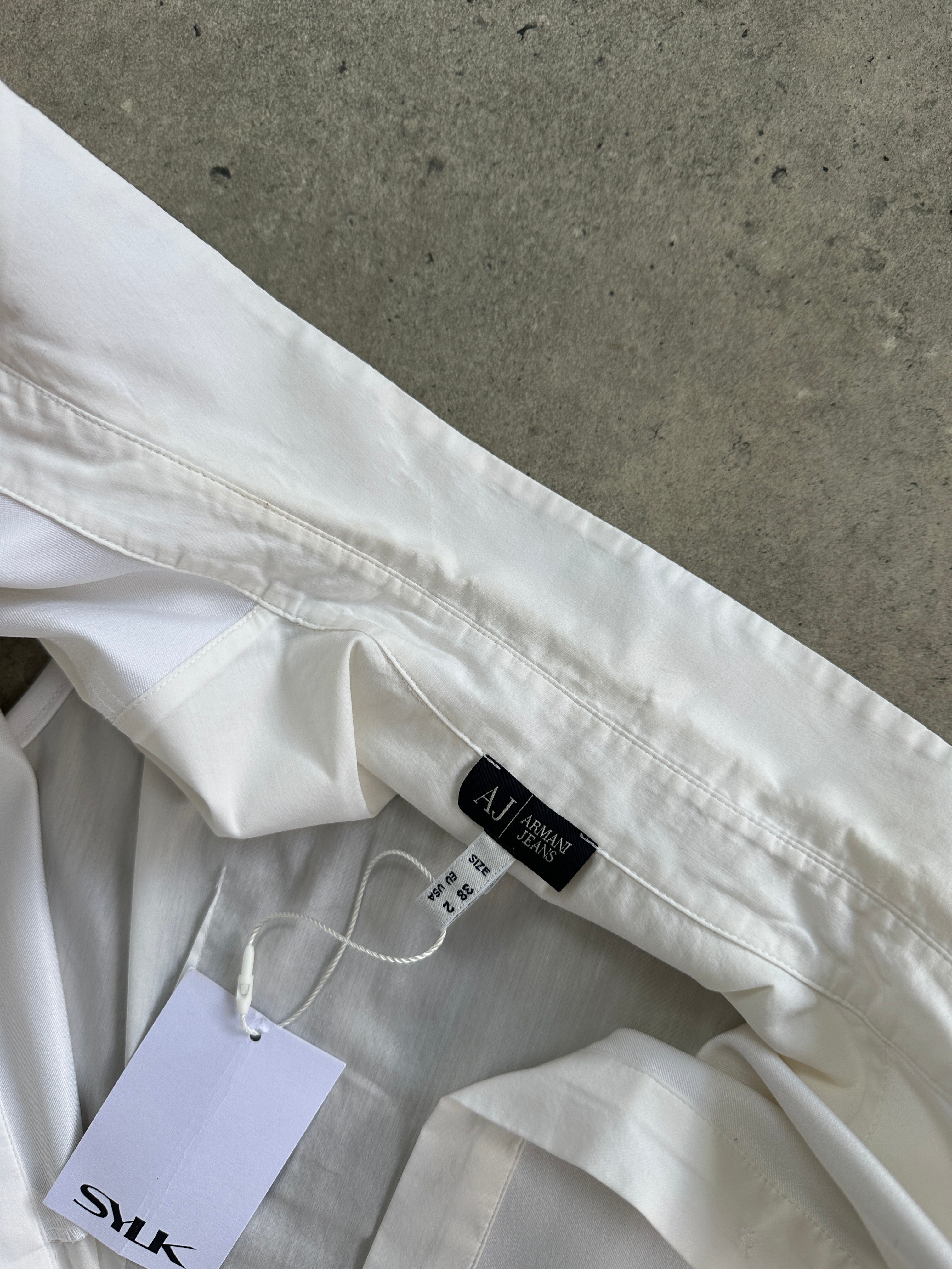 Armani Jeans sleeveless shirt in size small, white cotton shirt with sleeveless design and classic collar, front button closure.