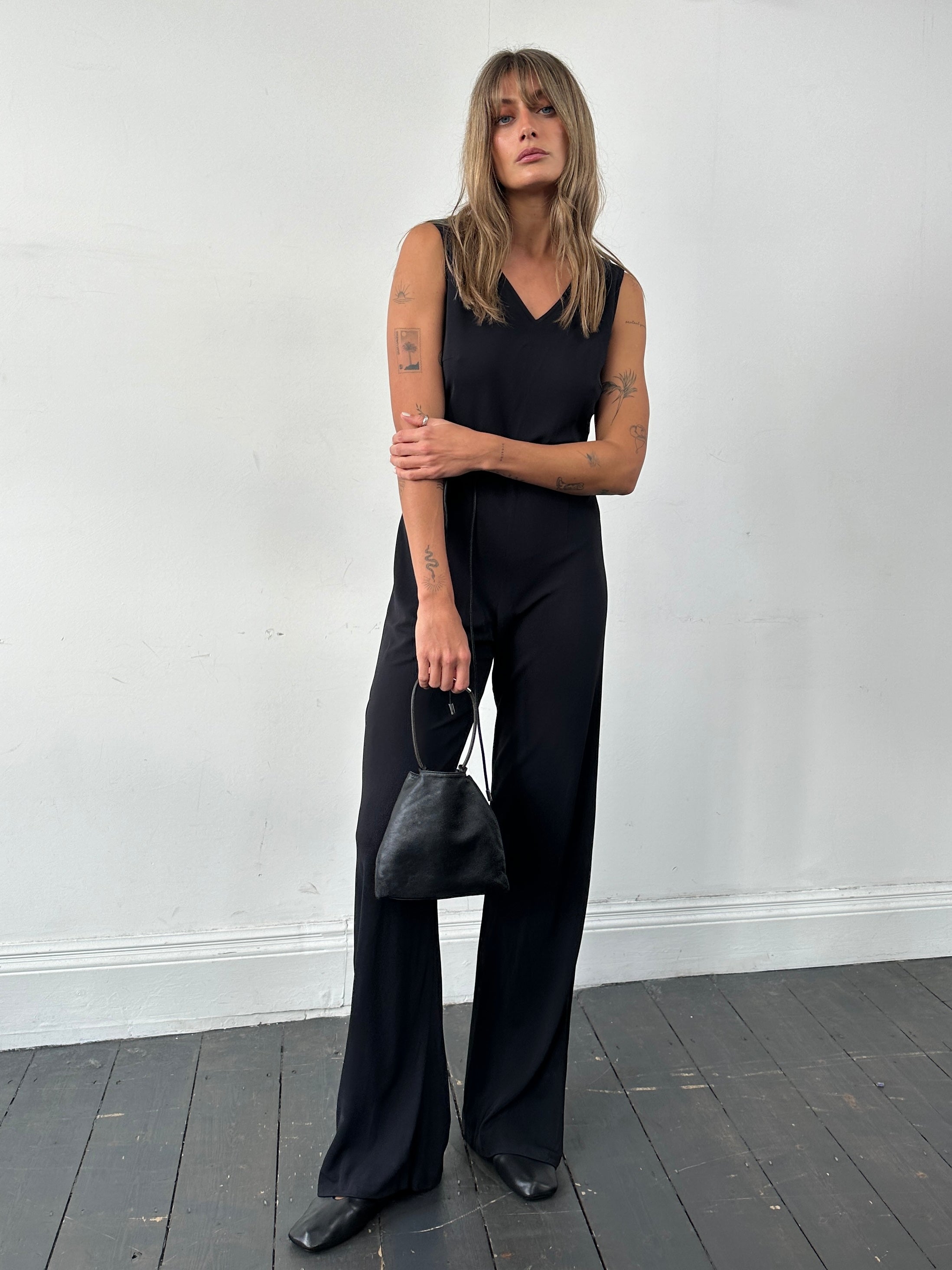 Vintage 80s V-neck stretch jumpsuit in size S/M, featuring a fitted silhouette and retro style, displayed on a mannequin.