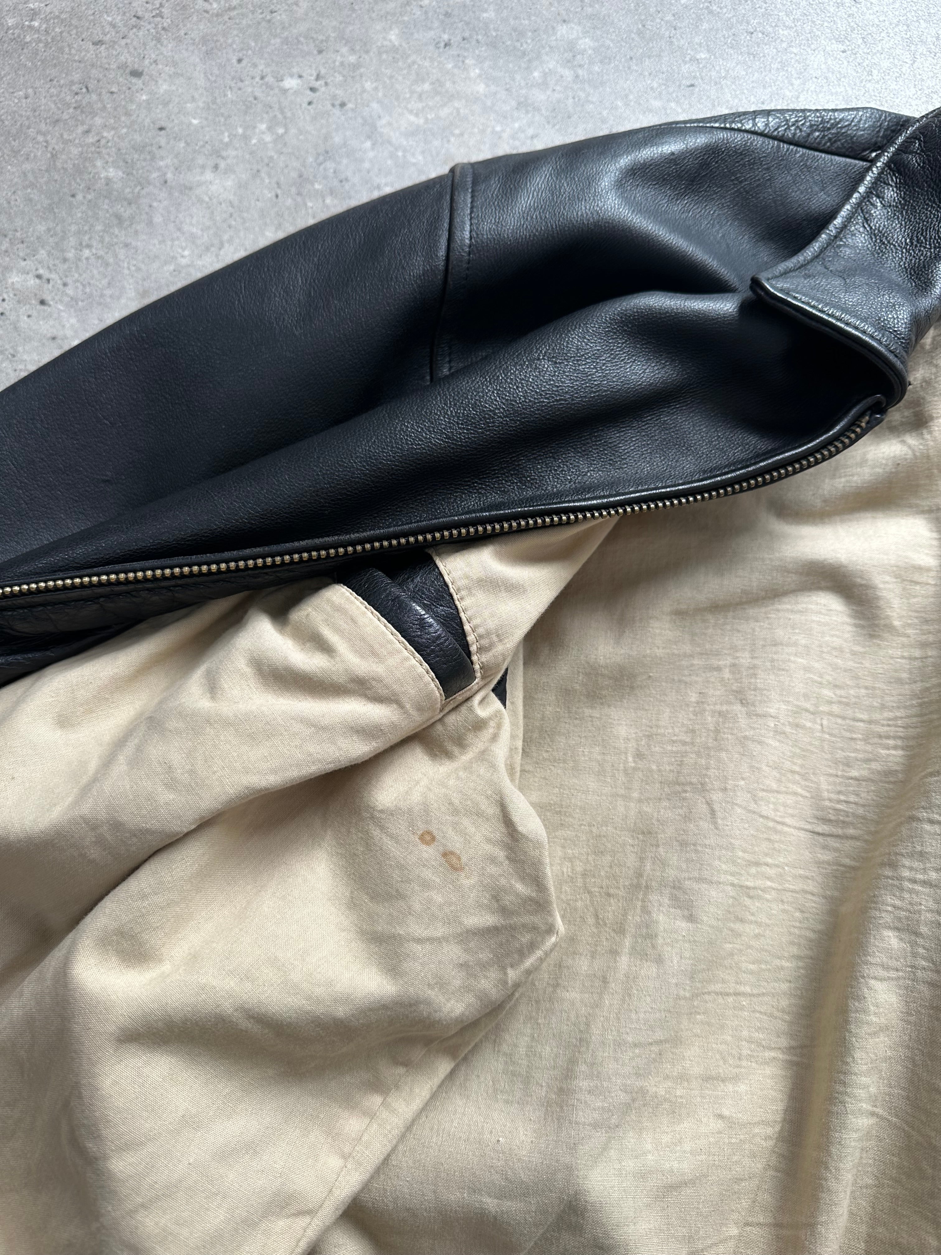 Vintage 1990s heavyweight leather jacket in black with minimal design, XXL size, featuring classic leather texture and sturdy construction.