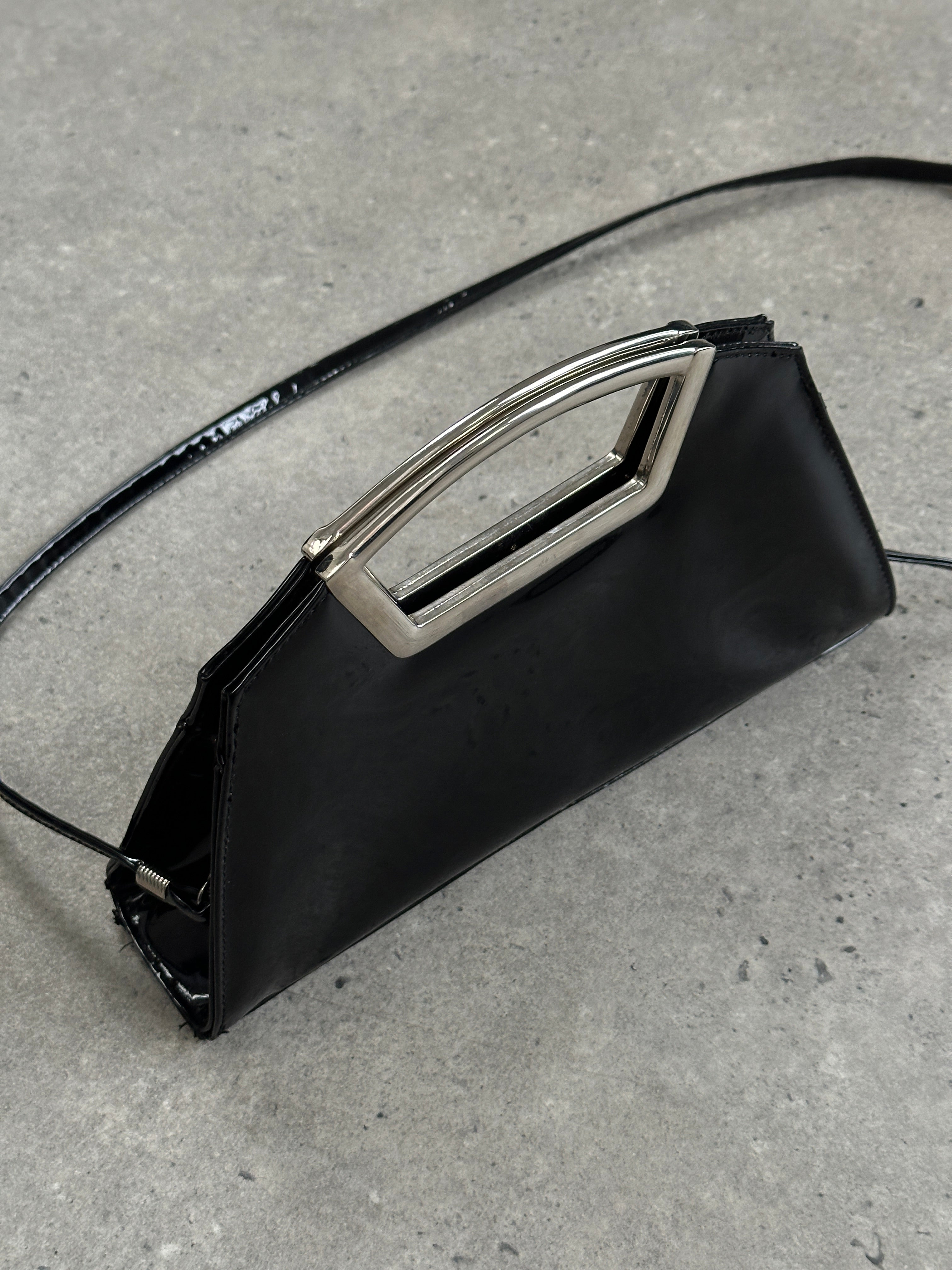 Vintage 2000s patent vinyl chrome crossbody clutch bag with sleek design and metallic finish.