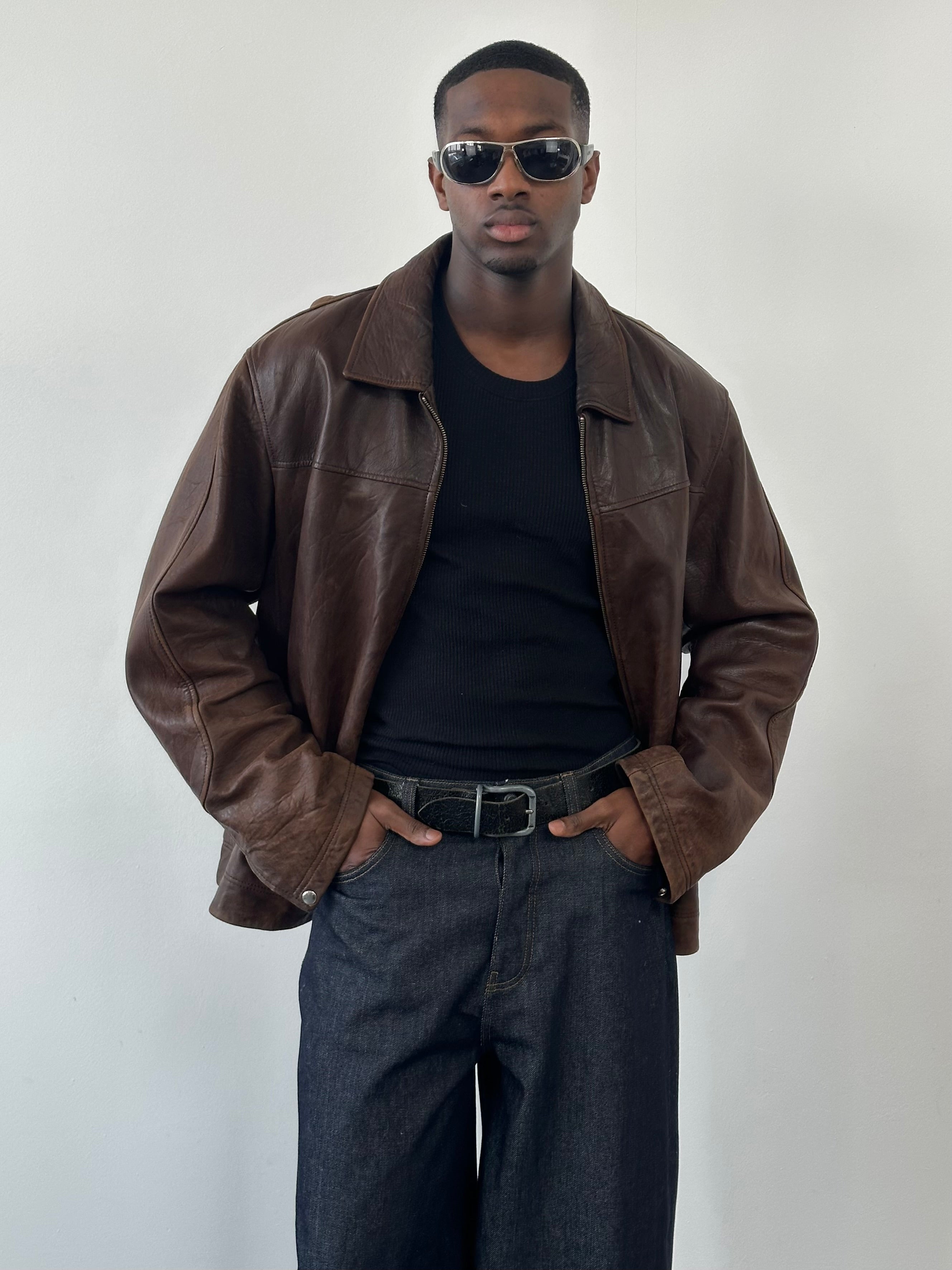 Vintage 1990s distressed leather jacket in XXL, showing rugged texture and classic style with worn details.