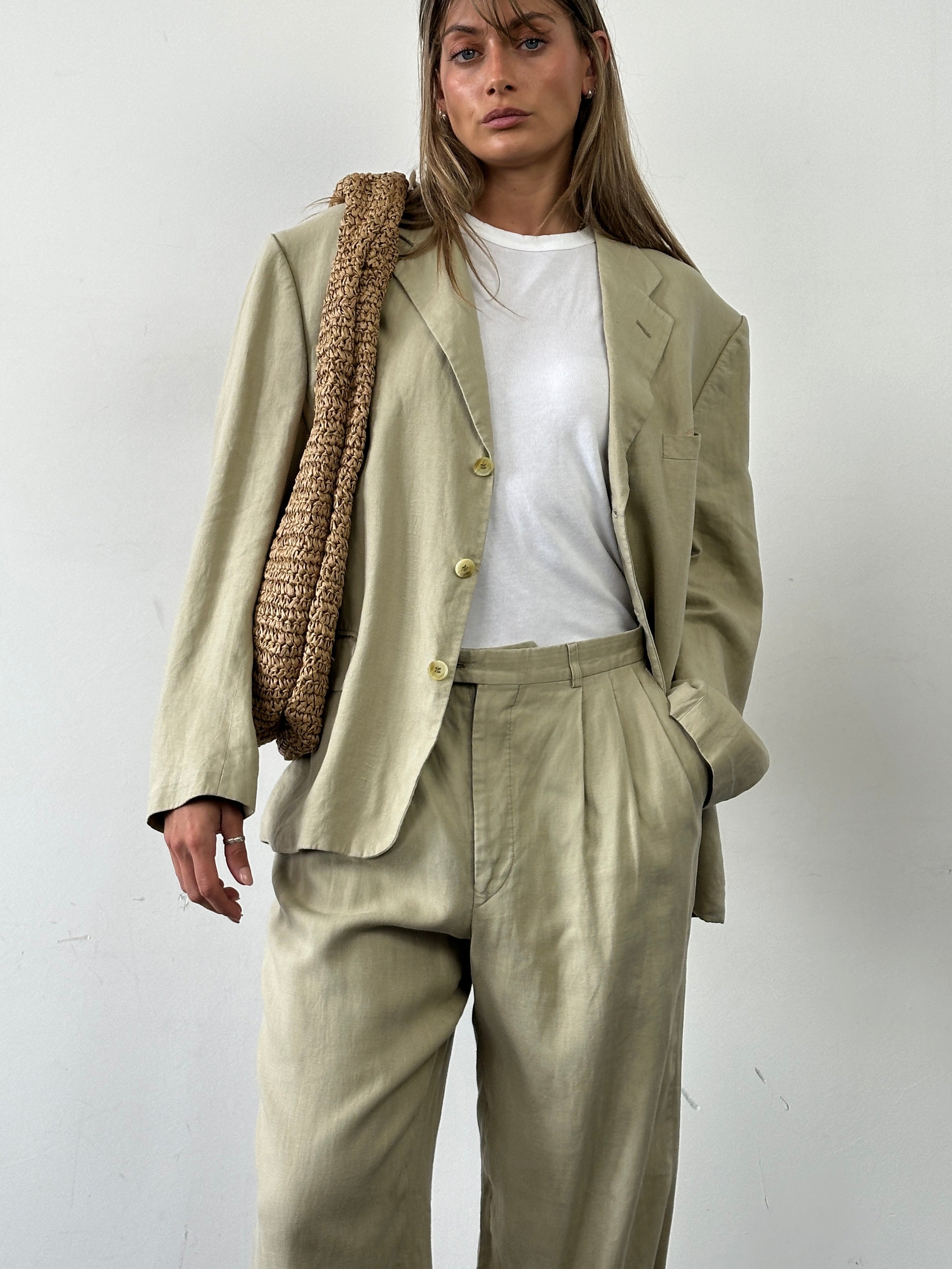Christian Dior Monsieur pure linen single-breasted suit jumpsuit in size 42S/W32, displayed on a hanger.
