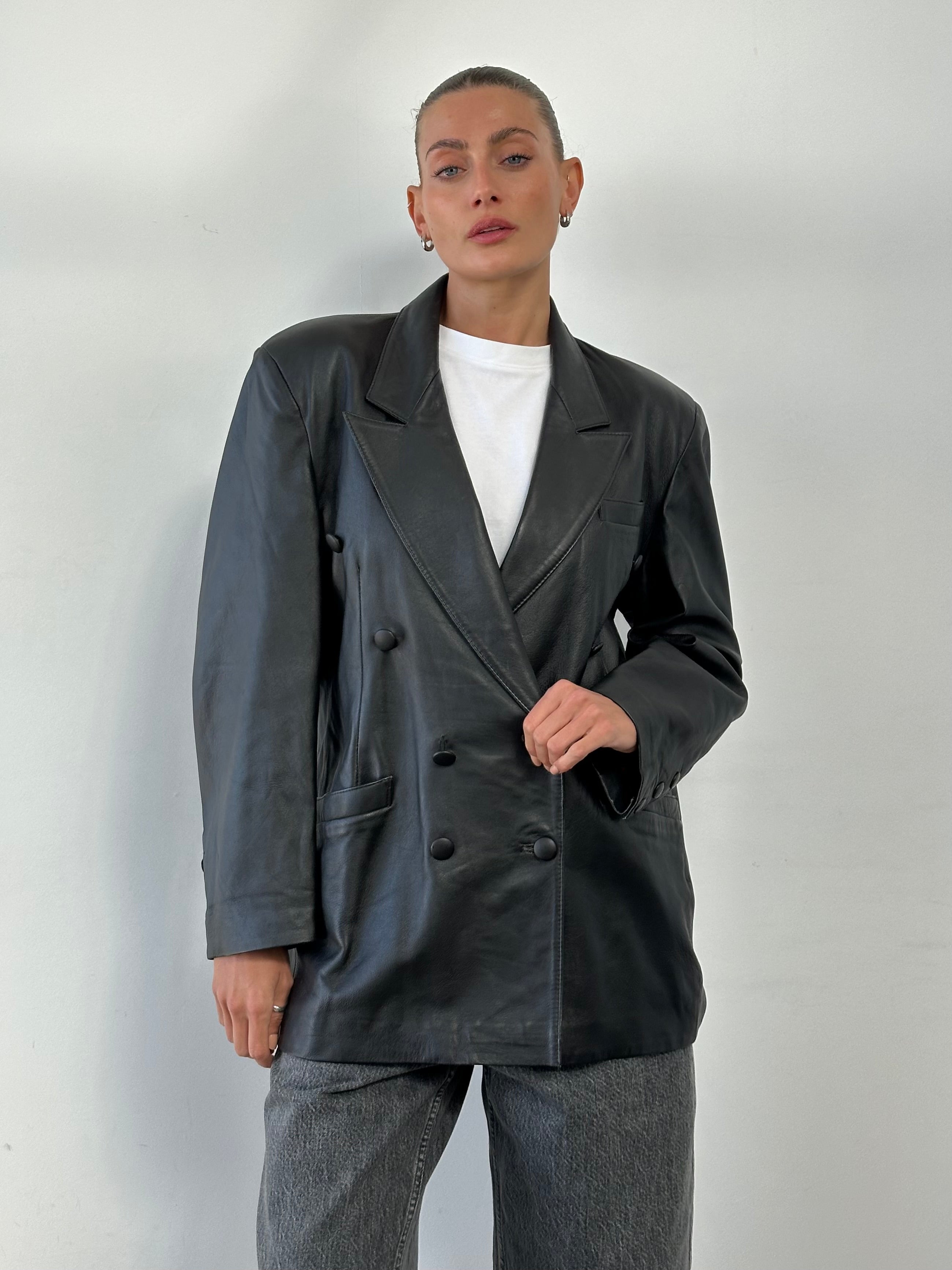 Vintage double-breasted leather blazer jacket in size large, featuring classic design and stylish lapels.