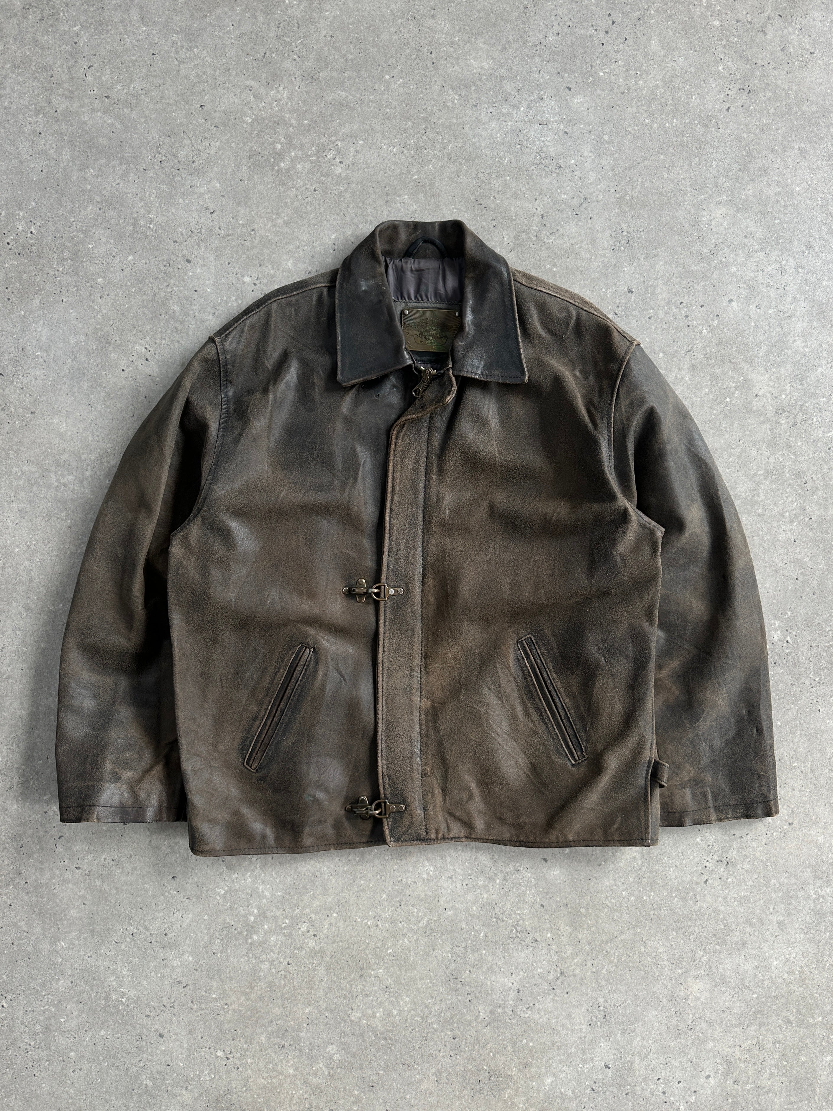 Vintage 1980s distressed leather jacket in XL size, featuring rugged texture and classic styling, displayed on a hanger.