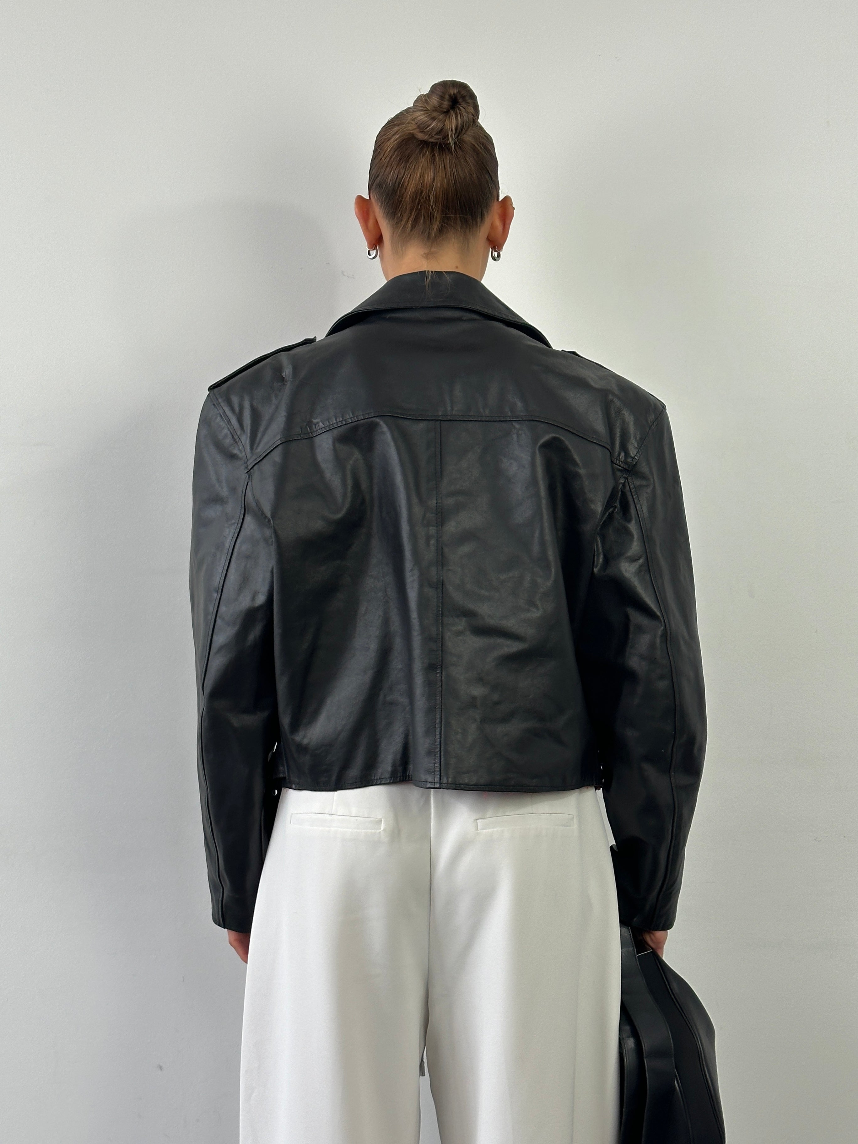 Vintage Italian vintage cropped leather biker jacket in size L, featuring classic design and detailed stitching.