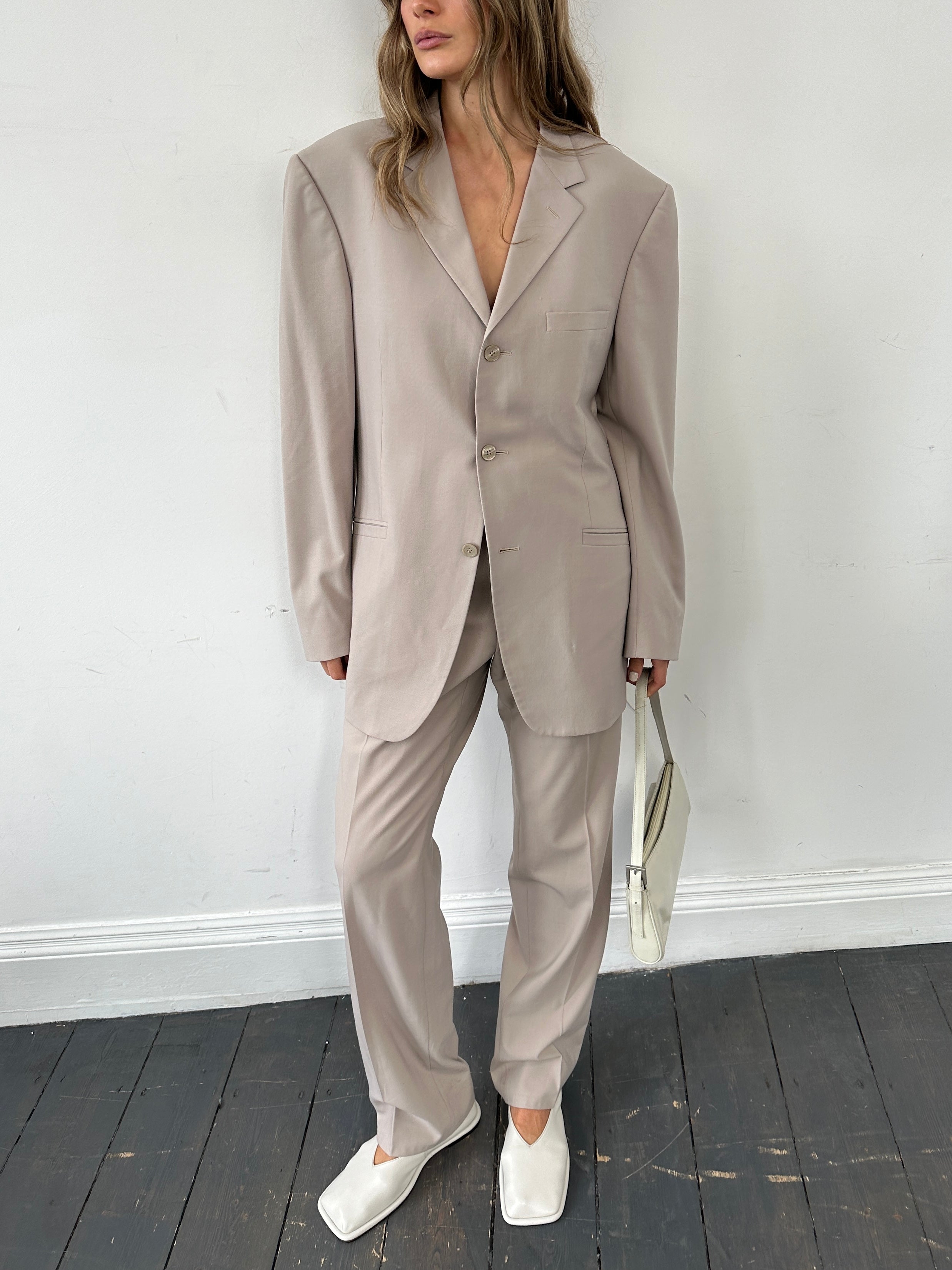 Versace single-breasted wool jumpsuit in size 42R/W30, tailored fit with classic lapels and sleek design.