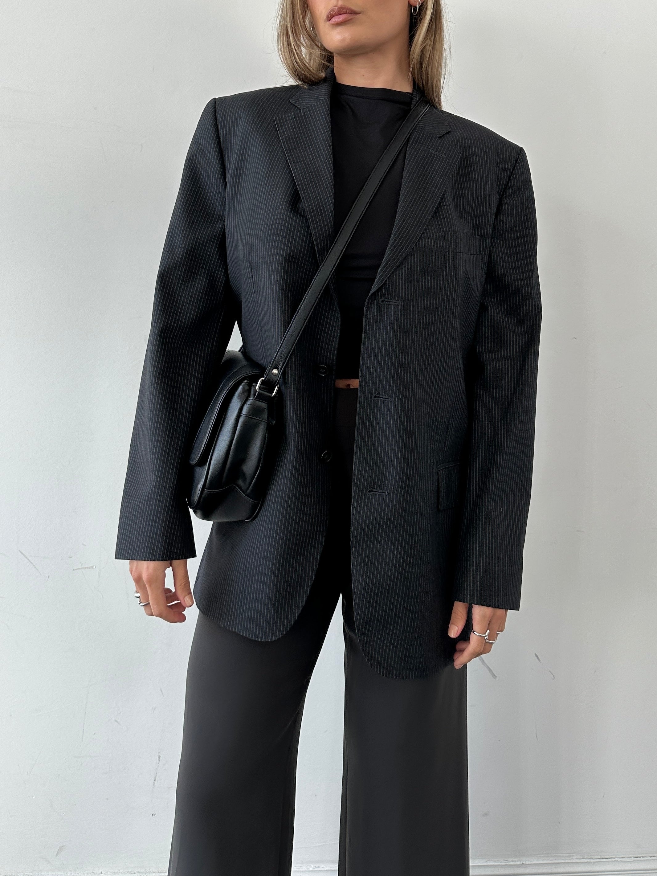 Jaeger pure wool pinstripe blazer in size 40R/M displayed on a hanger, showing classic tailored fit and navy pinstripe pattern.