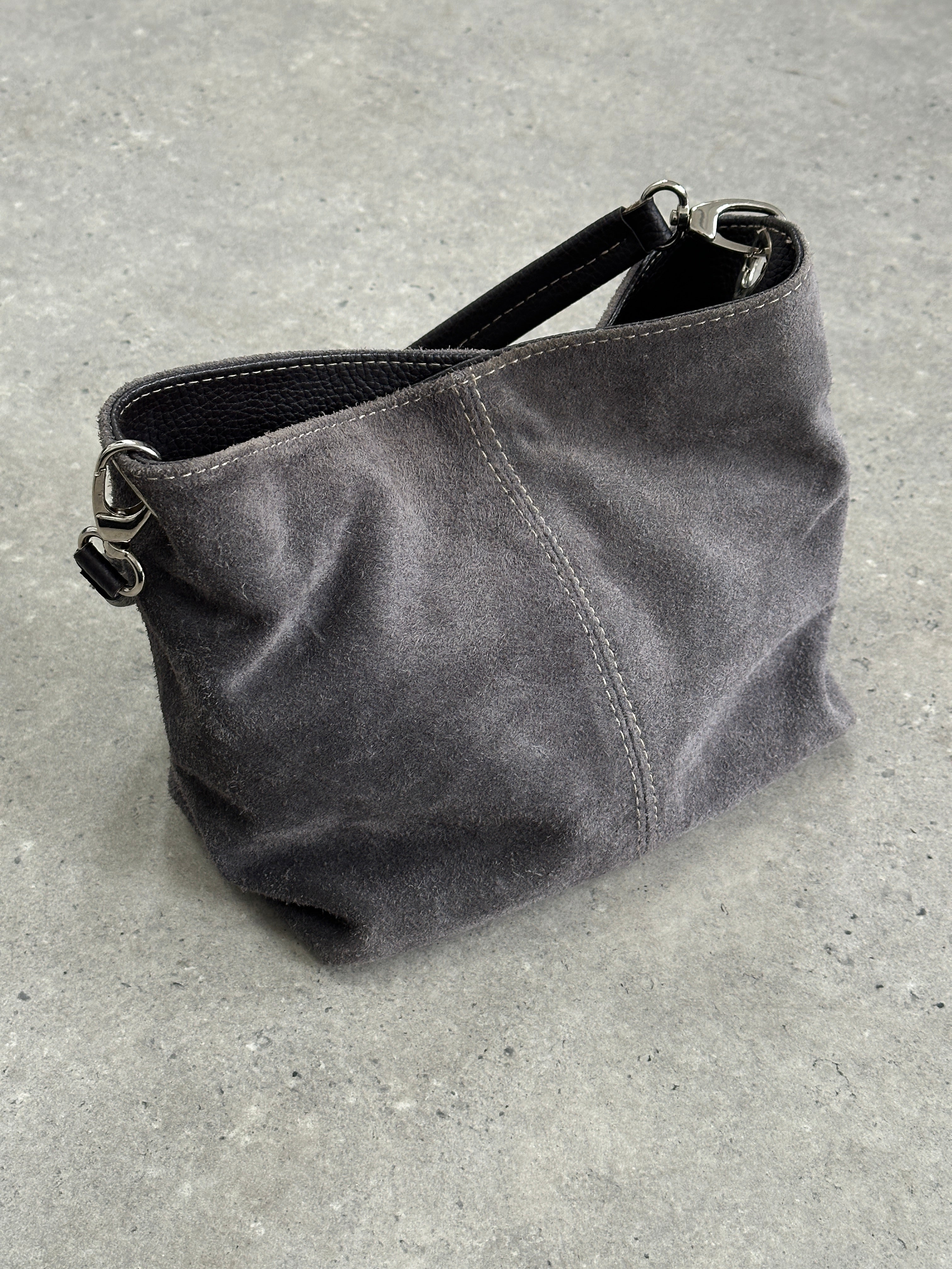 Vintage suede leather shoulder bag with a classic design, featuring a long strap and vintage-style detailing.