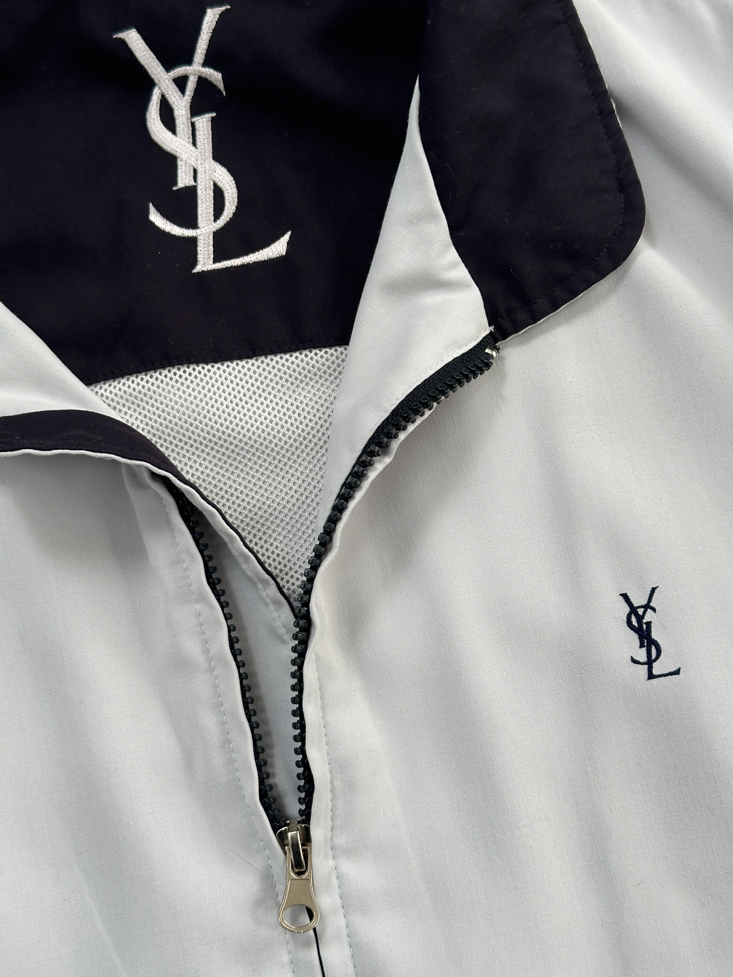 Yves Saint Laurent Pour Homme 1990s logo hooded bomber jacket in XL with front zipper and logo patch on chest.