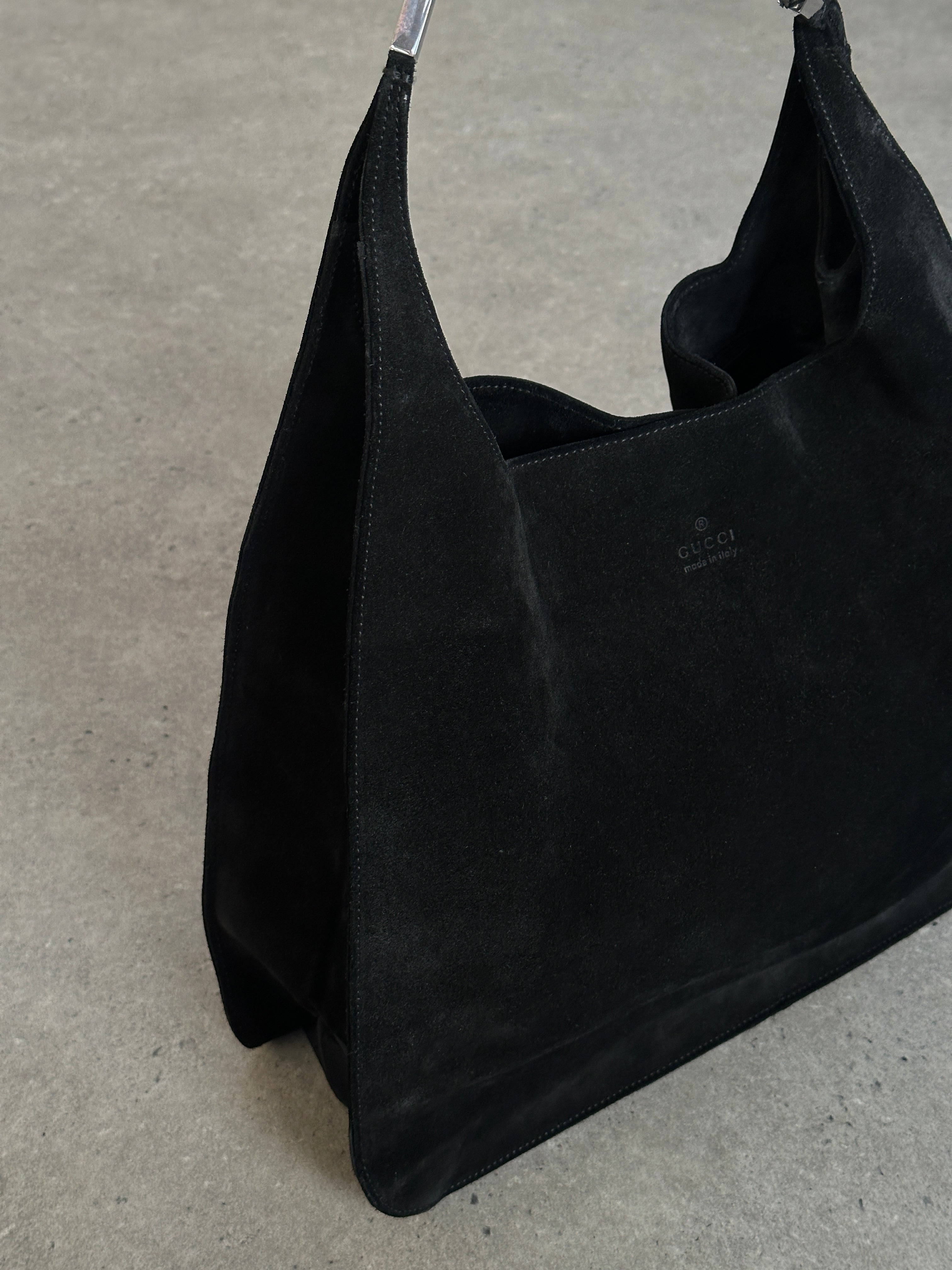 Gucci suede shoulder bag with adjustable strap and gold-tone hardware, featuring a sleek and stylish design.