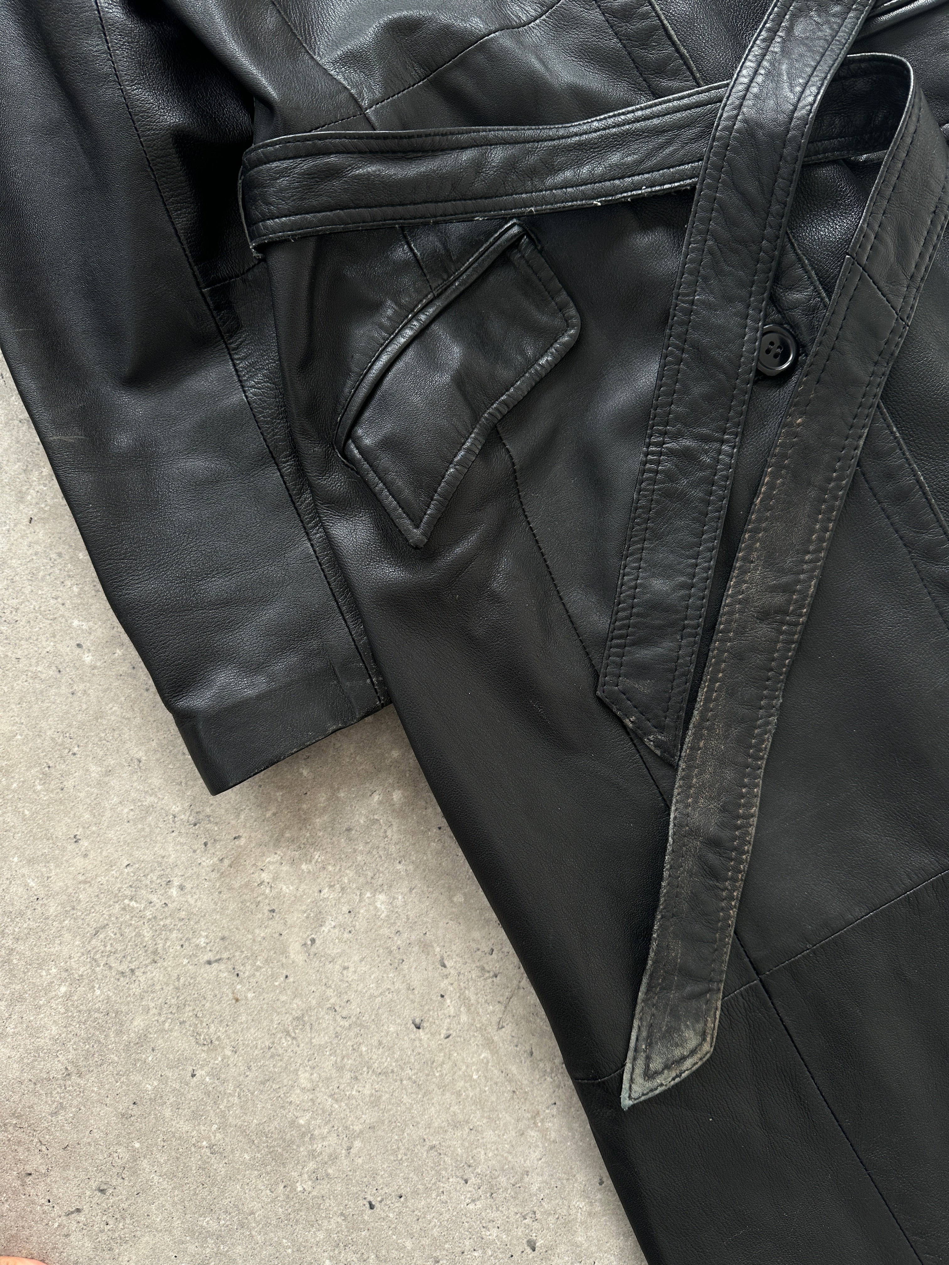 Vintage leather belted trench coat in floor length style, size small, shown on a hanger with classic design and tailored fit.