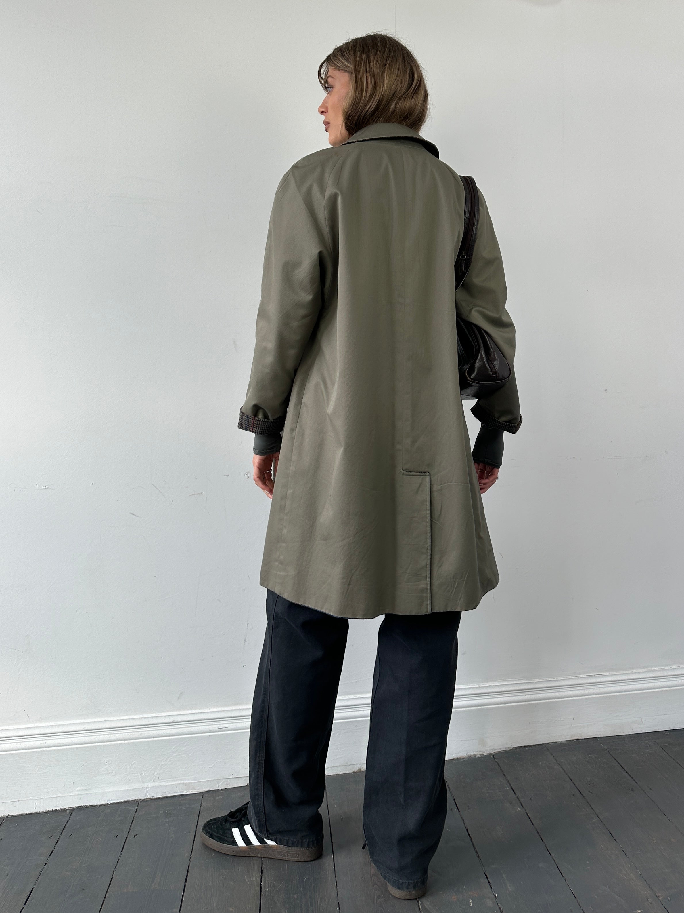 Vintage British vintage reversible wool trench coat in size small, showing classic design and textured fabric detail.