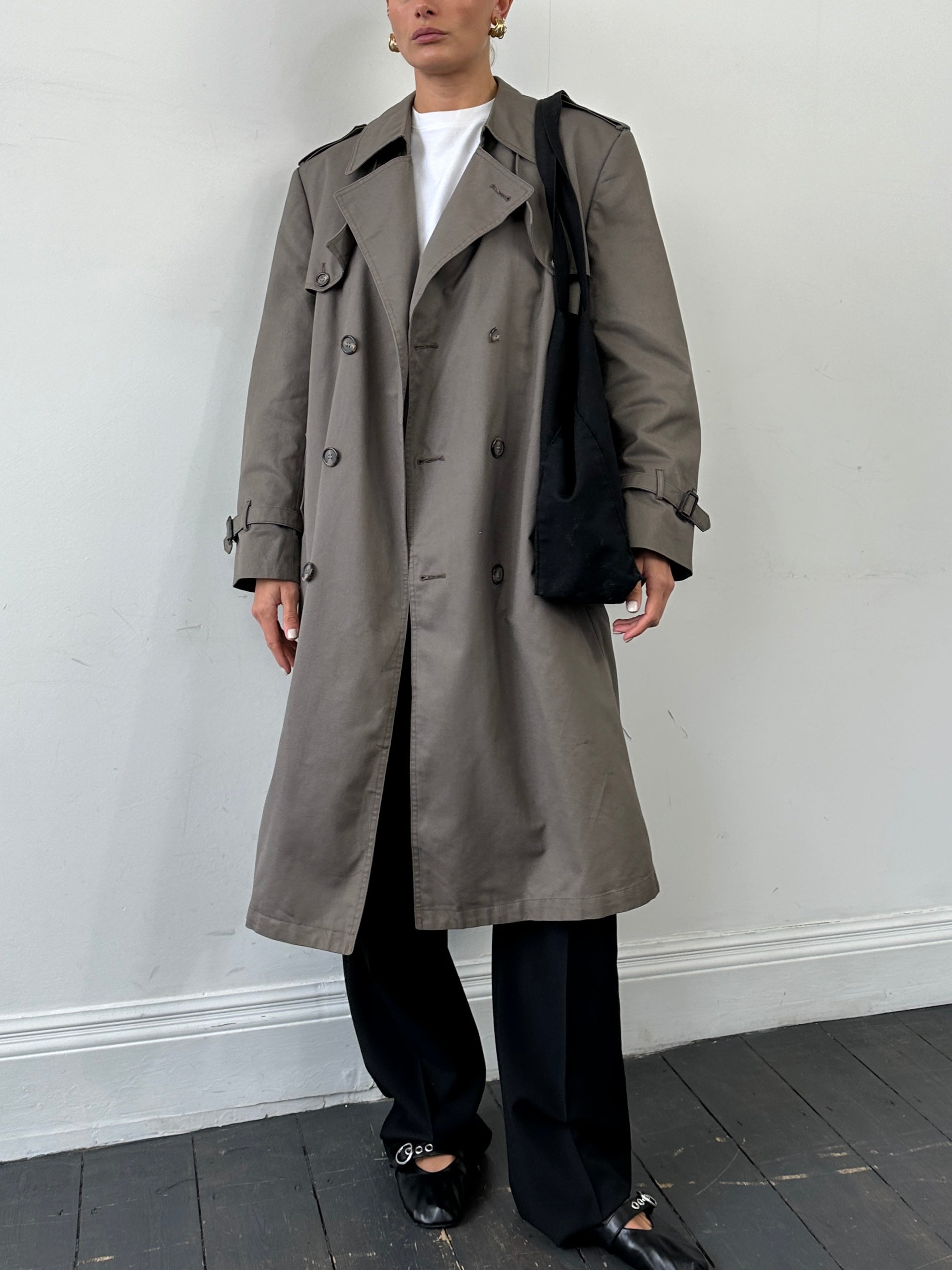 Christian Dior Monsieur double-breasted belted trench coat in classic beige, displayed on a hanger.