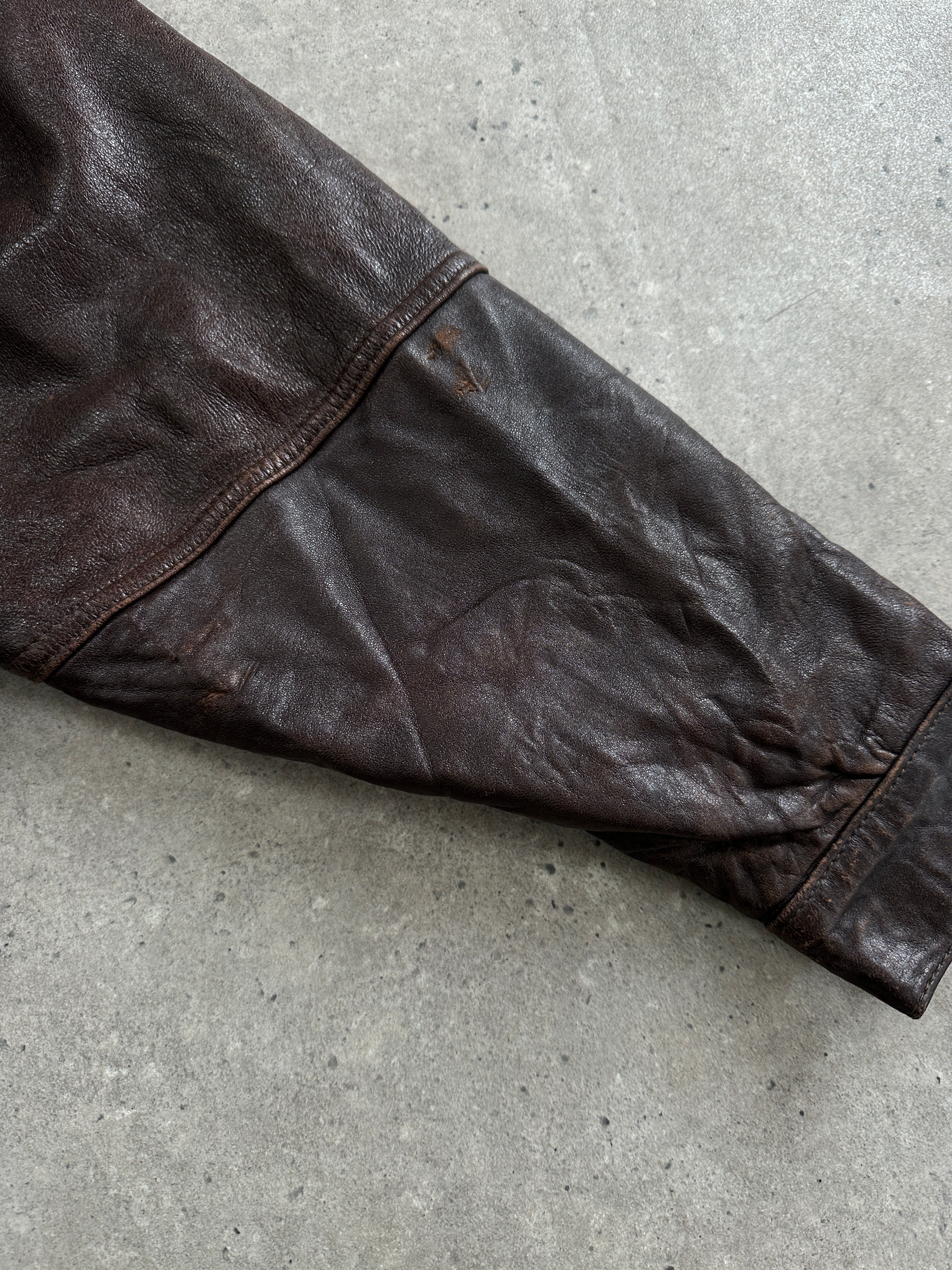 Vintage 1970s high neck leather motorcycle bomber jacket in XL with classic black leather and metal zipper details.