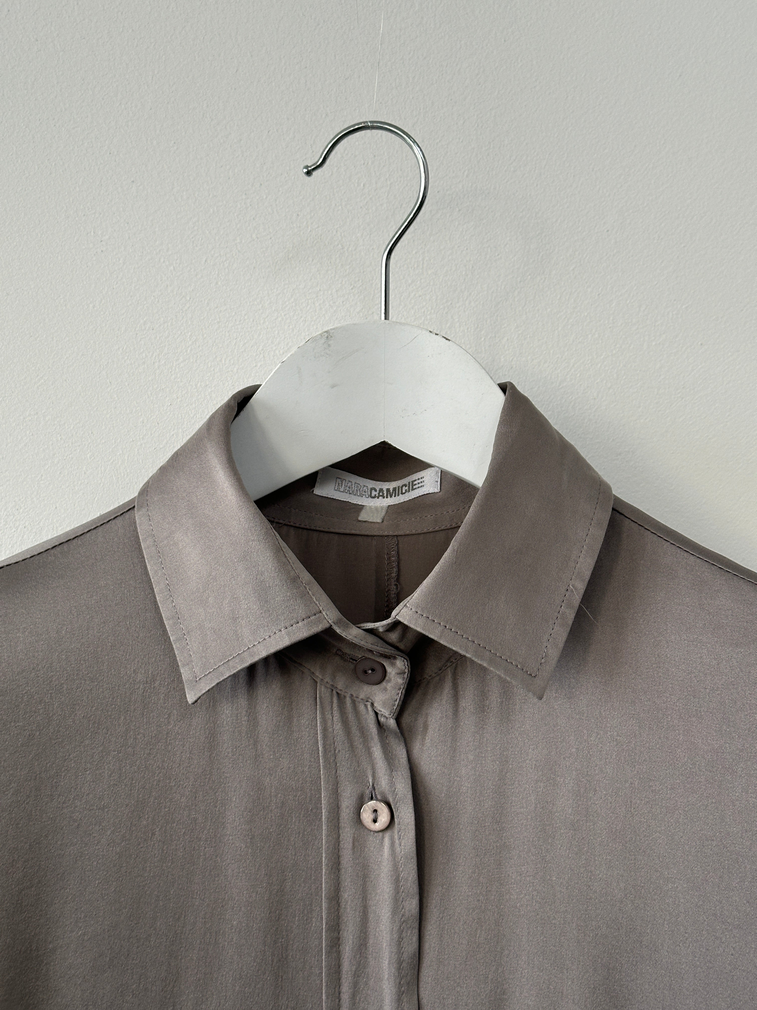 Vintage silk shirt in size M, featuring a classic design and soft fabric, displayed on a hanger.