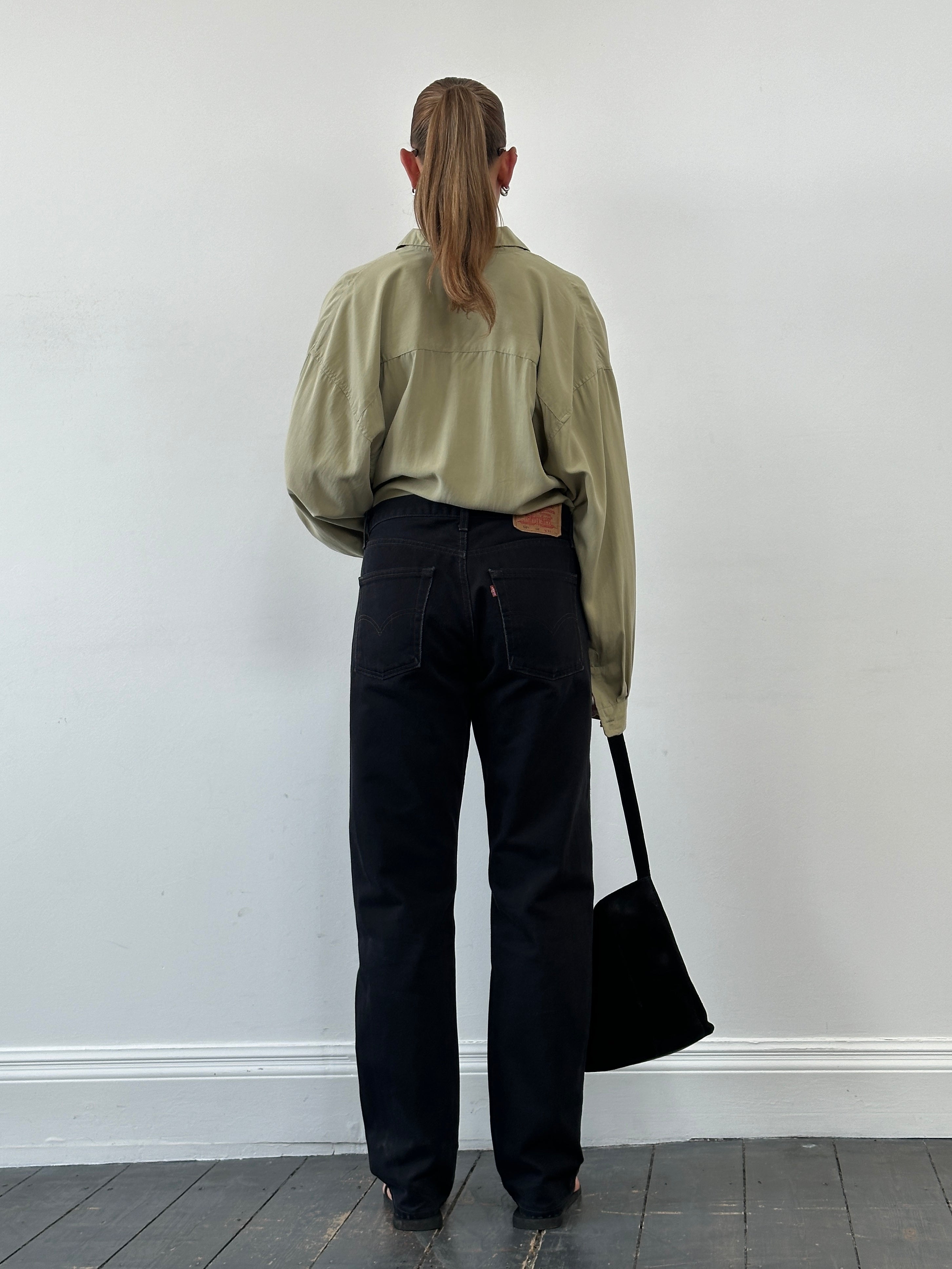 Levi’s 521 tapered straight leg denim jeans in W31, showing classic blue denim fabric with a mid-rise waistband and front pockets.