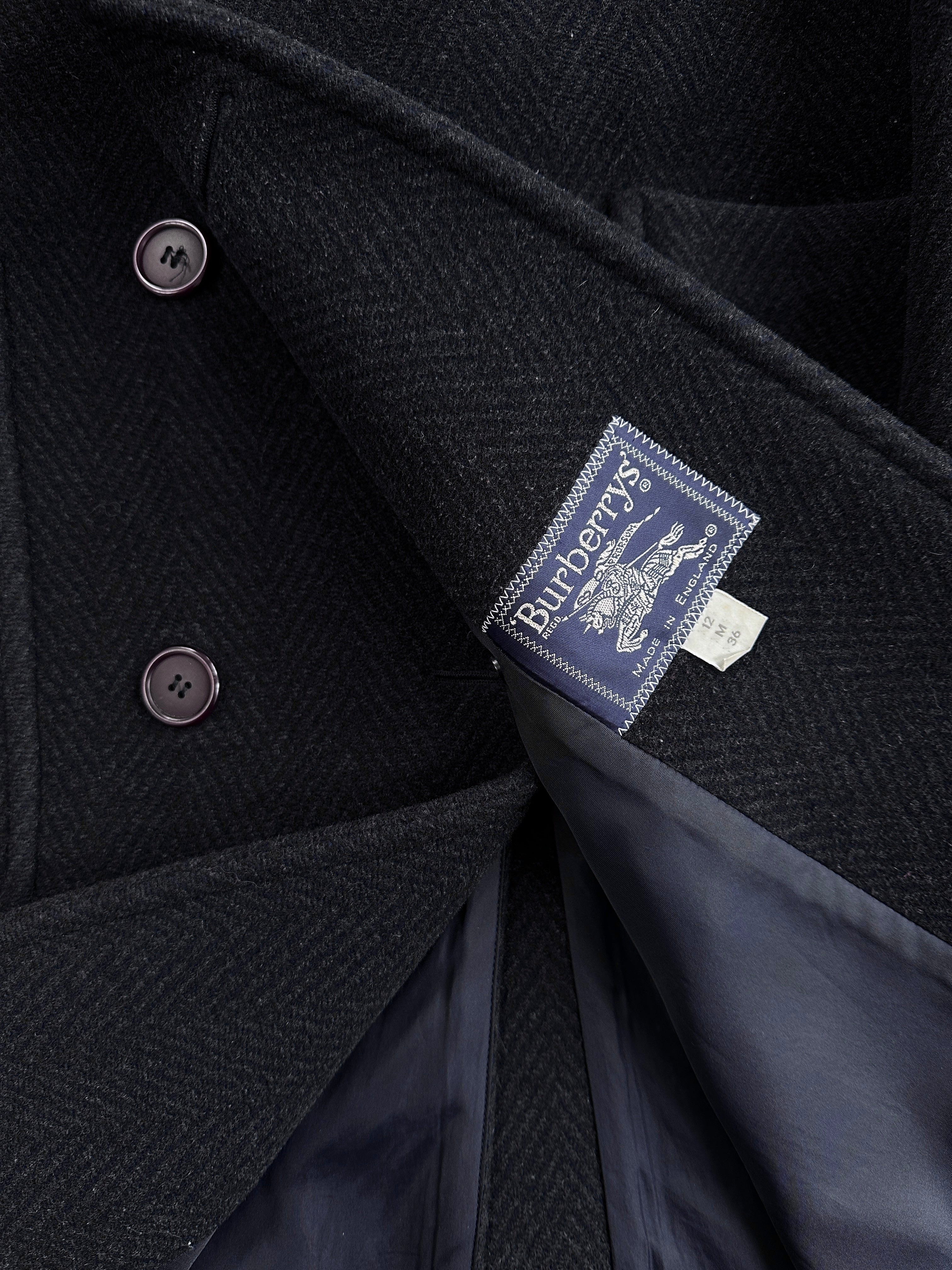 Burberry 1990s herringbone wool double-breasted coat in size M/L displayed on a hanger, showcasing classic British style.