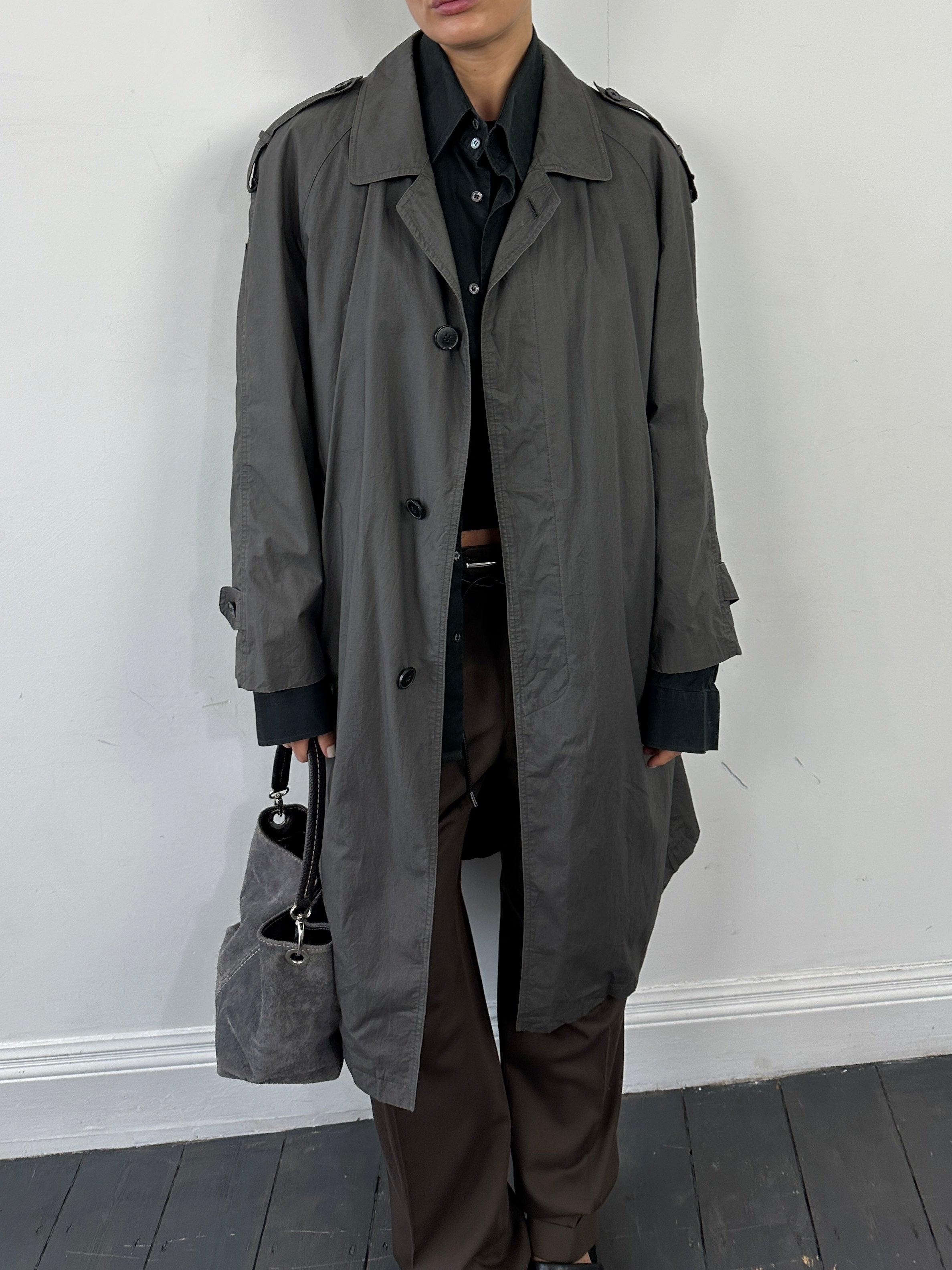 Yves Saint Laurent Pour Homme cotton trench coat with concealed placket, in classic style, shown on a model.