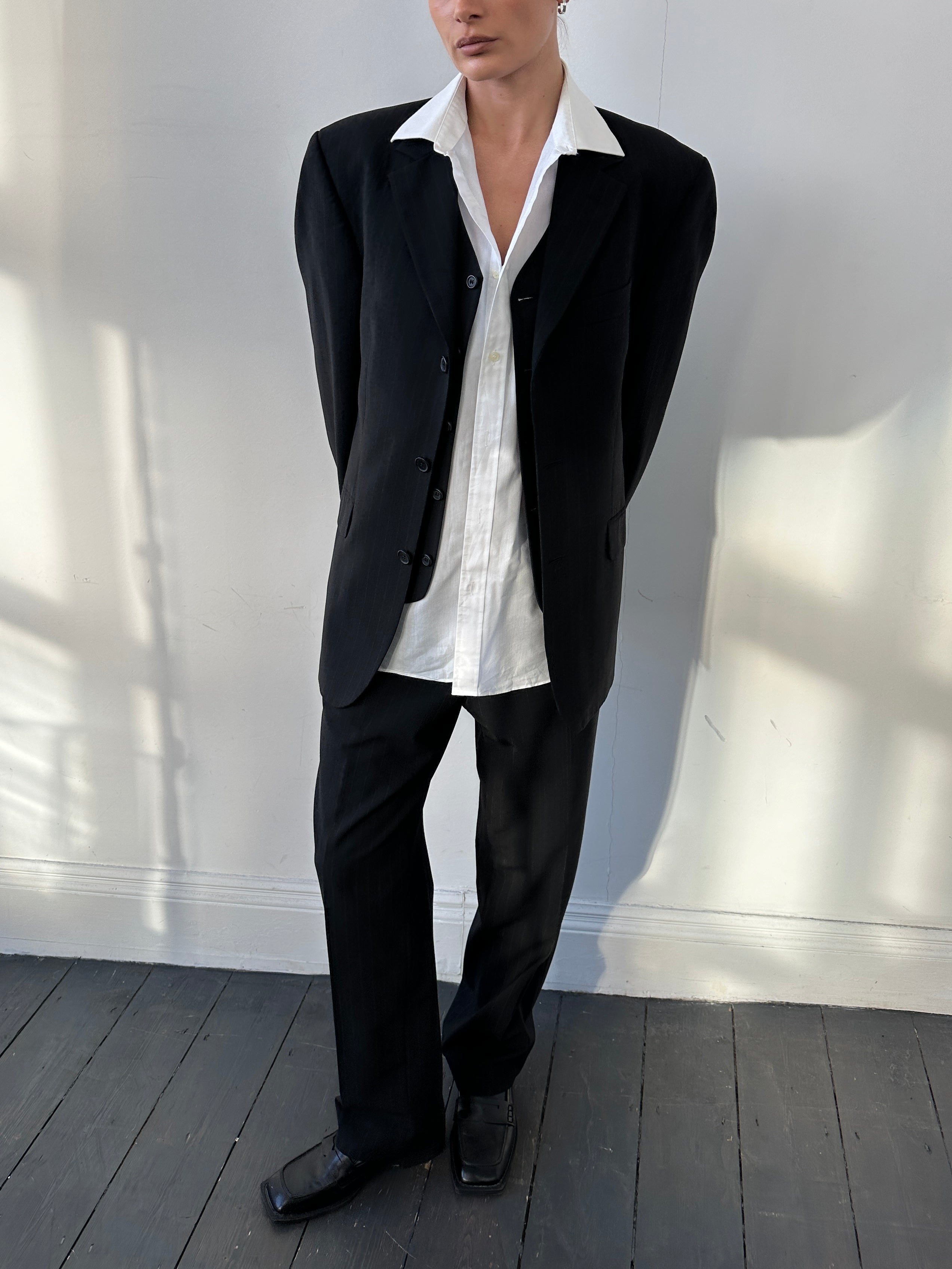 Vintage pinstripe wool three-piece suit with jacket, vest, and trousers in size 40R/W32, tailored for a classic, sophisticated look.