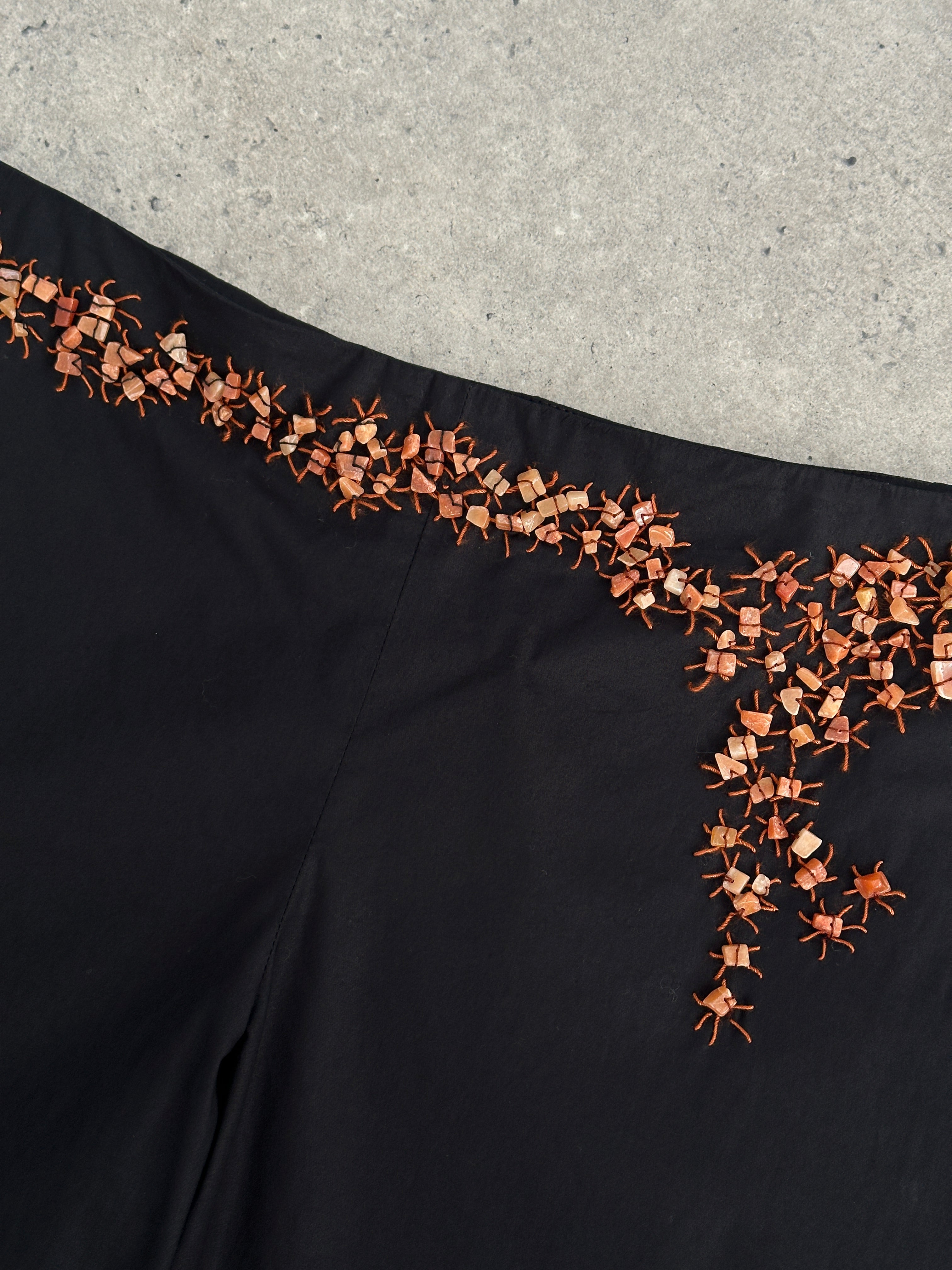 Vintage Alberta Ferretti mid-waist wide-leg trousers with stone embellishments, showcasing elegant details and relaxed fit.
