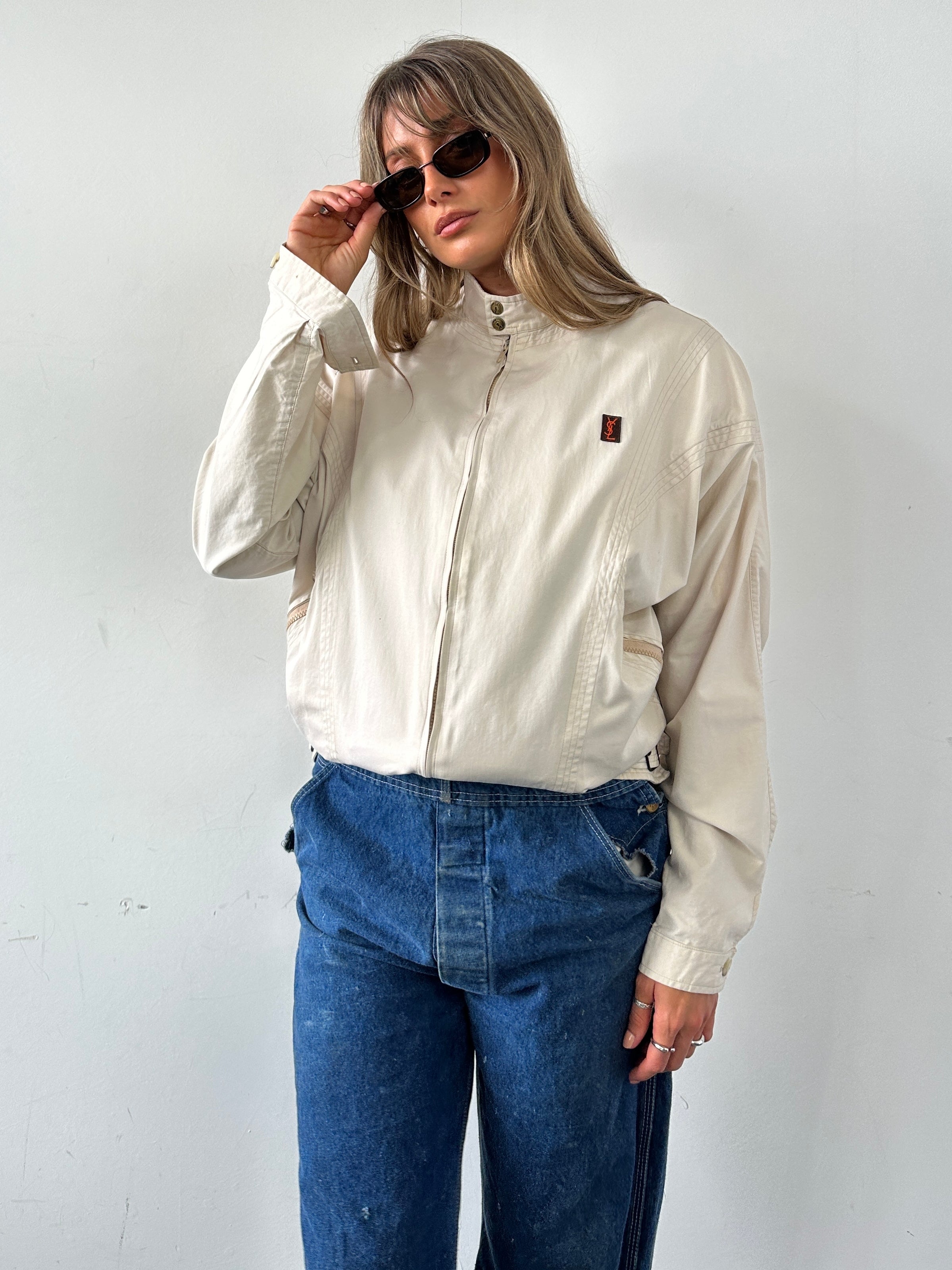 Yves Saint Laurent 70s logo bomber jacket in black, front view, showcasing classic design and embroidered branding, size M/L.