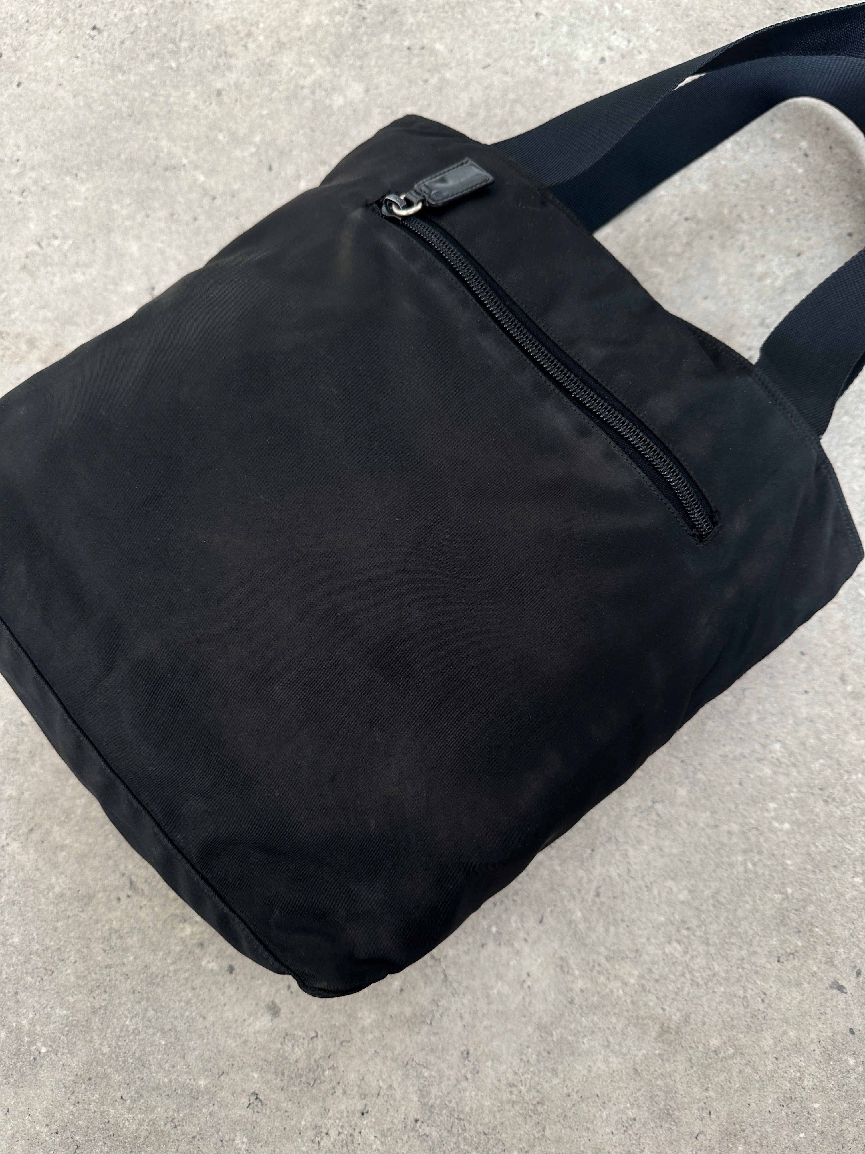 Prada 1997 nylon shoulder bag with adjustable strap and sleek design, featuring the iconic Prada logo on the front.