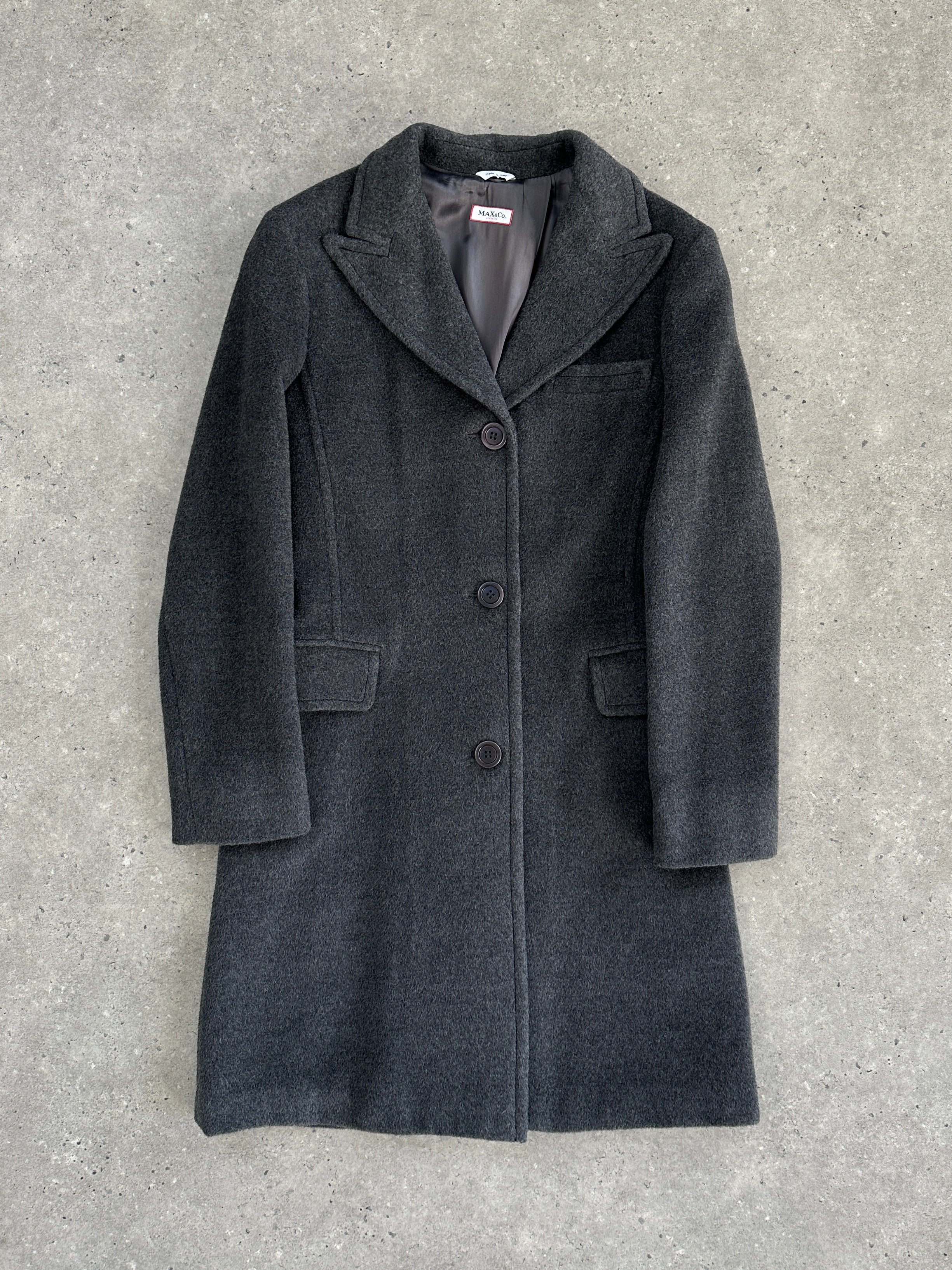 MAX & Co wool single-breasted coat in XS displayed on a hanger, showcasing classic design and tailored fit.
